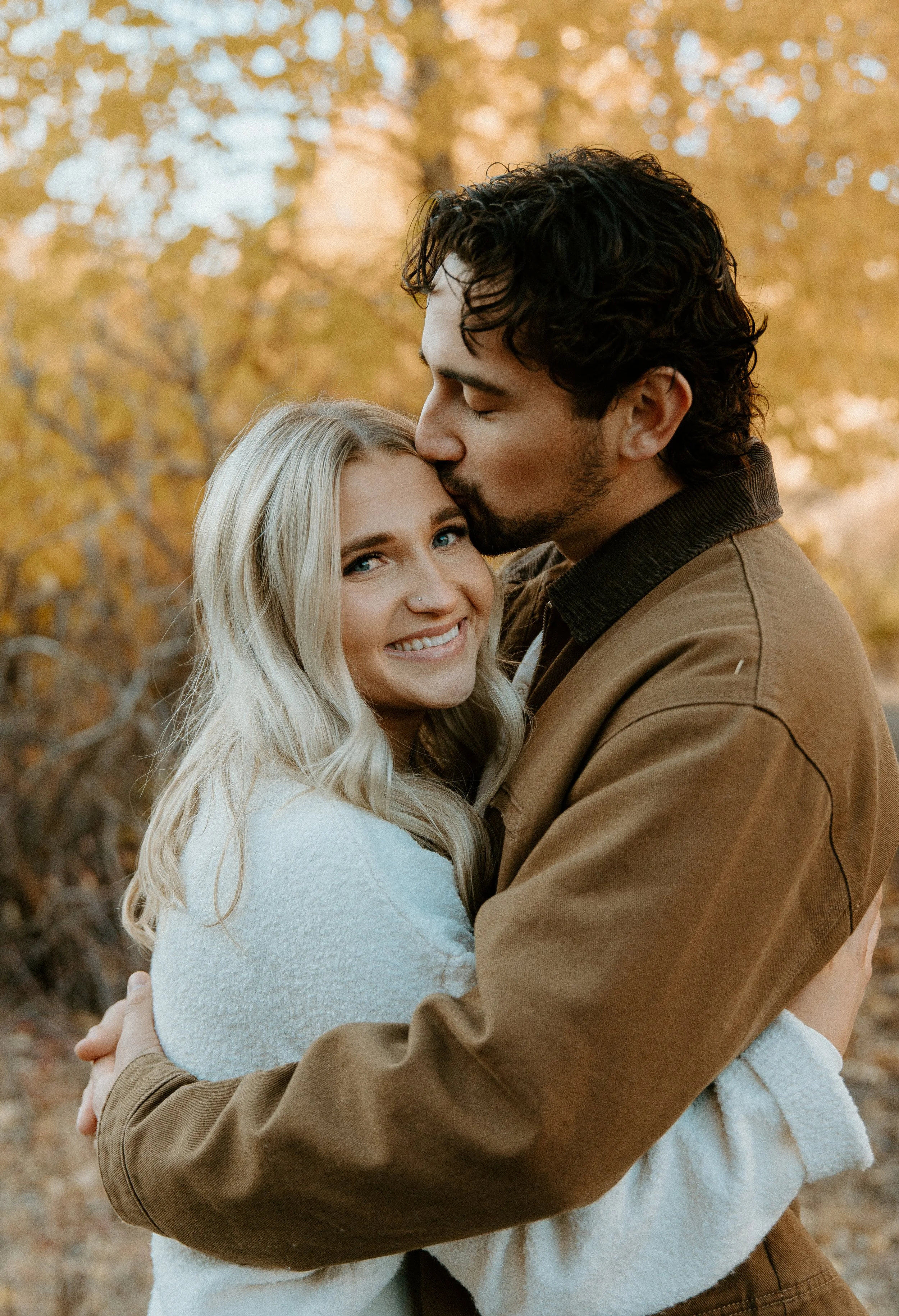 couple smiling at camera during fall engagement session + Yakima Washington + golden tones