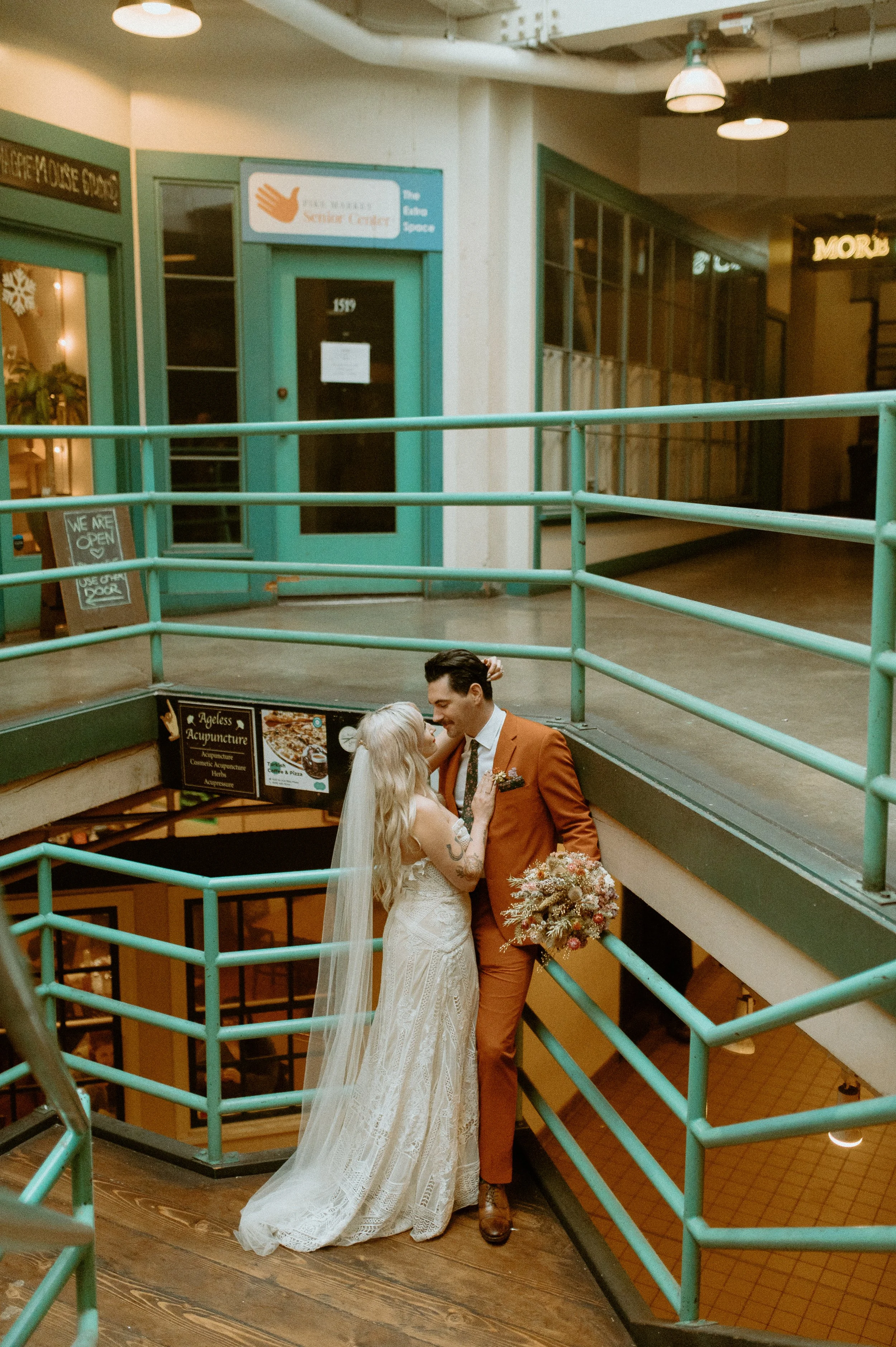 Bride and groom smiling together on a staircase during a Seattle city elopement