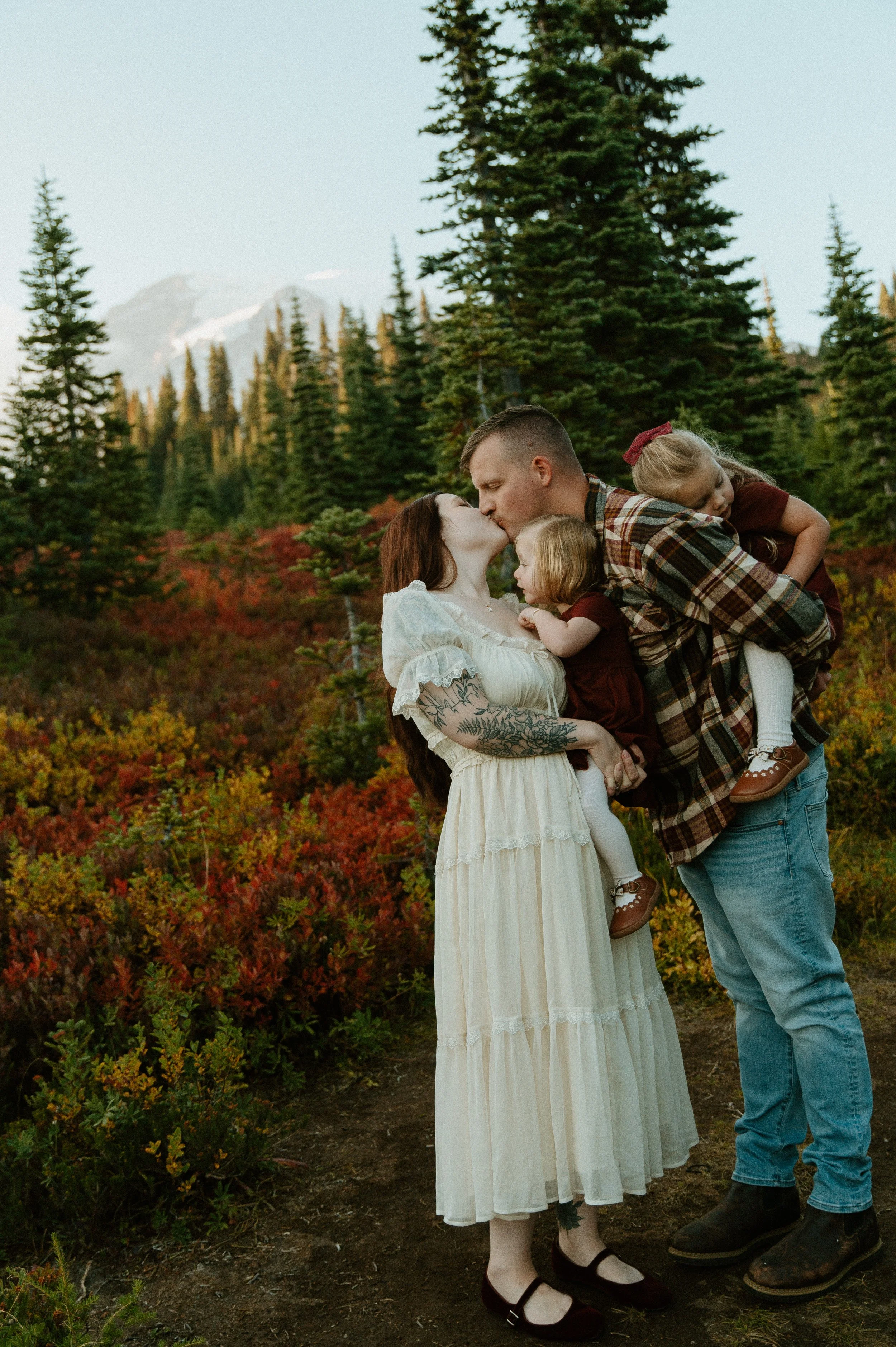    .    Family of four embracing during a fall family photography session at Mount Rainier in Washington
