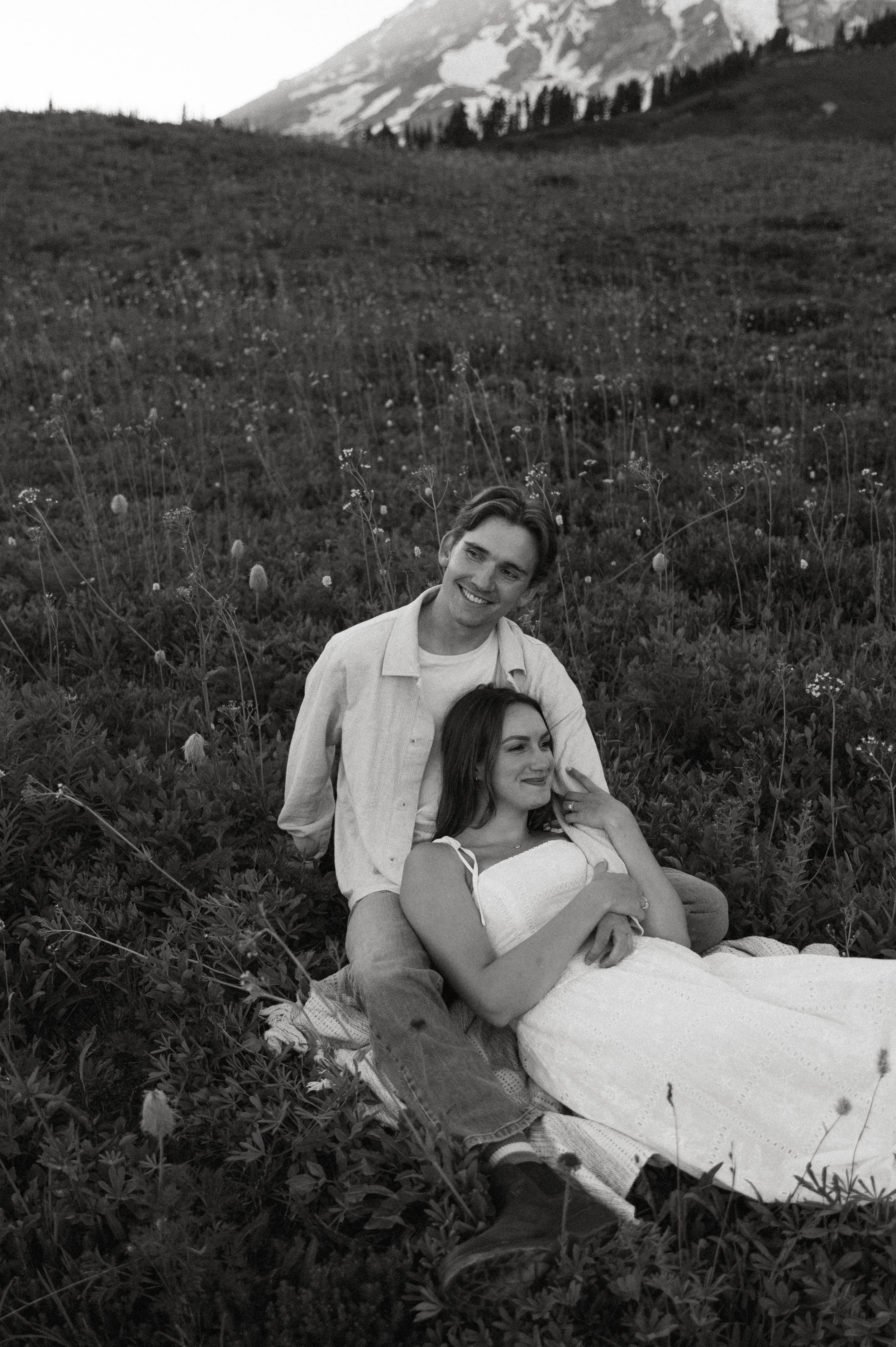 Black-and-white photo of a couple cuddling together during their Mount Rainier engagement session