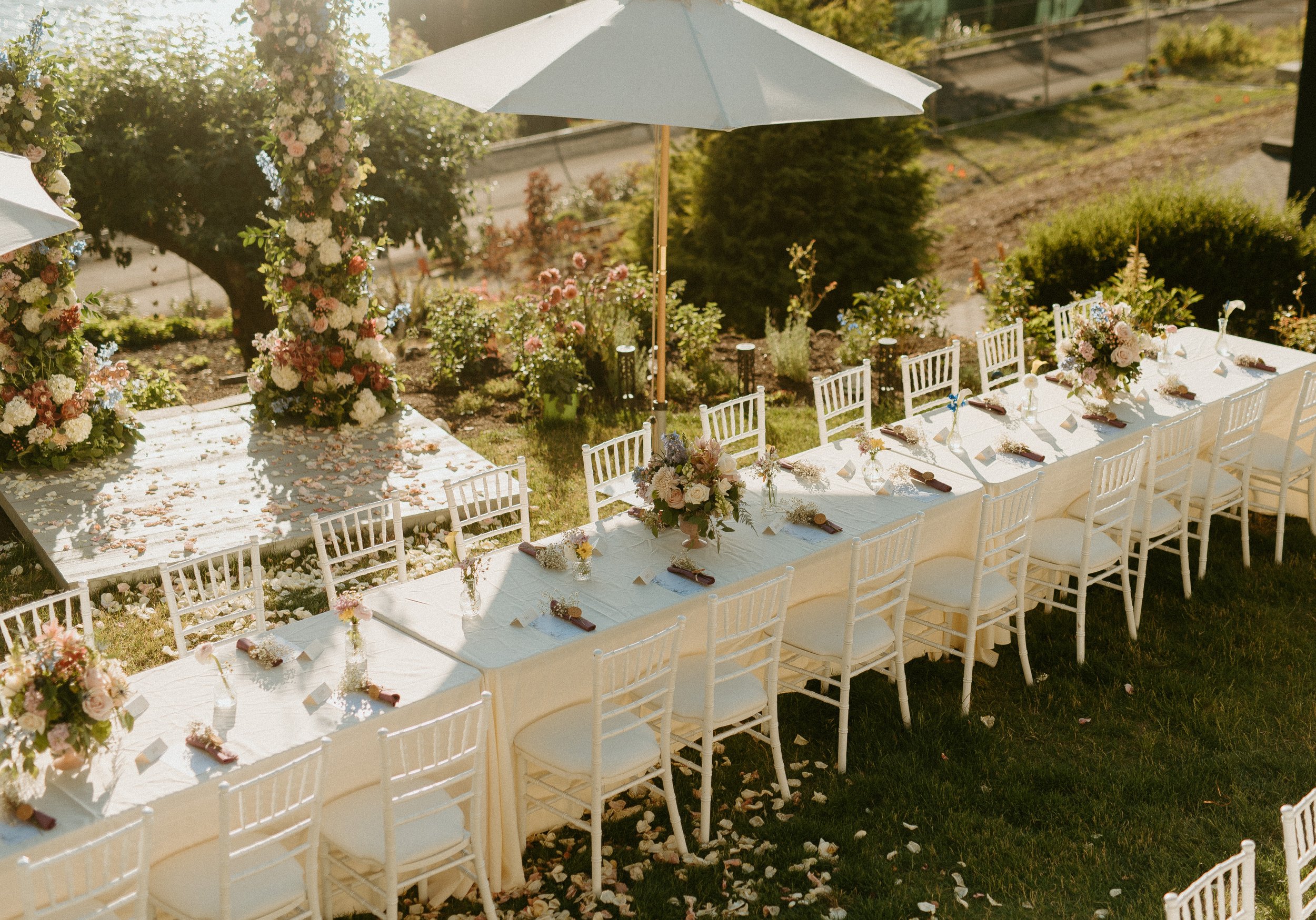 Elegant outdoor reception tablescape with floral ceremony arch at Seattle backyard wedding