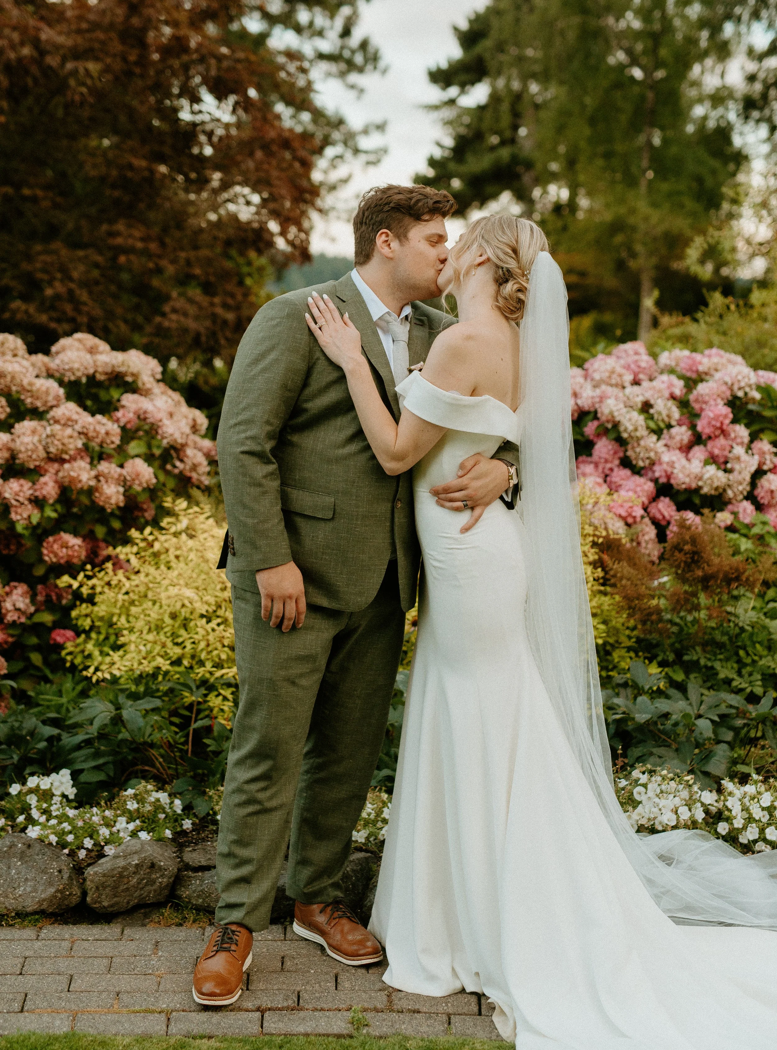Bride and groom kissing in garden with pink hydrangeas + romantic garden wedding + Washington wedding + Seattle wedding photographer
