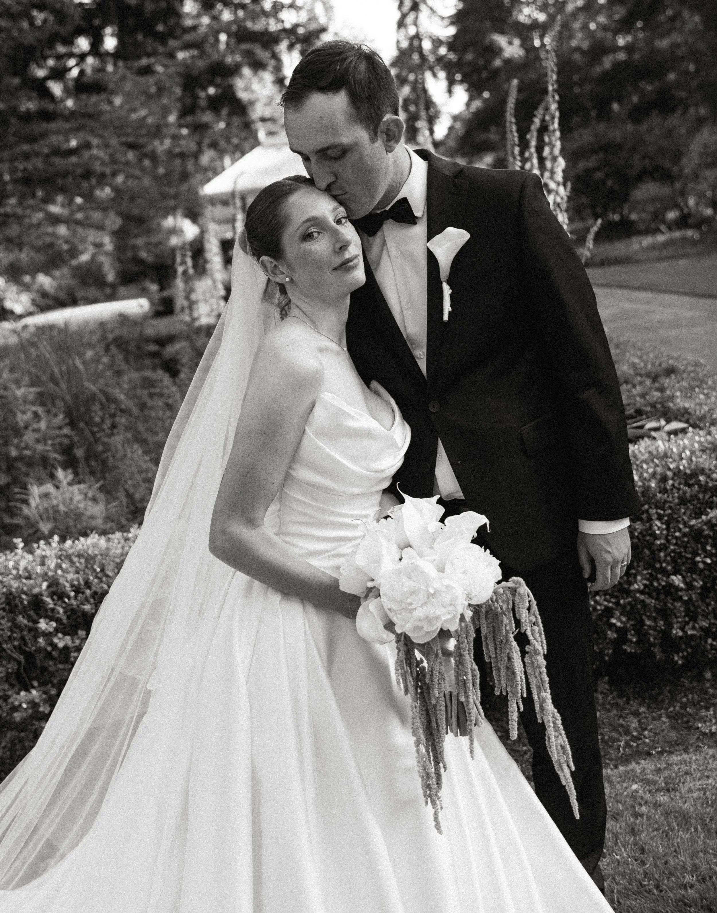Romantic black and white portrait of a bride and groom in the gardens at Lakewold Gardens wedding venue.