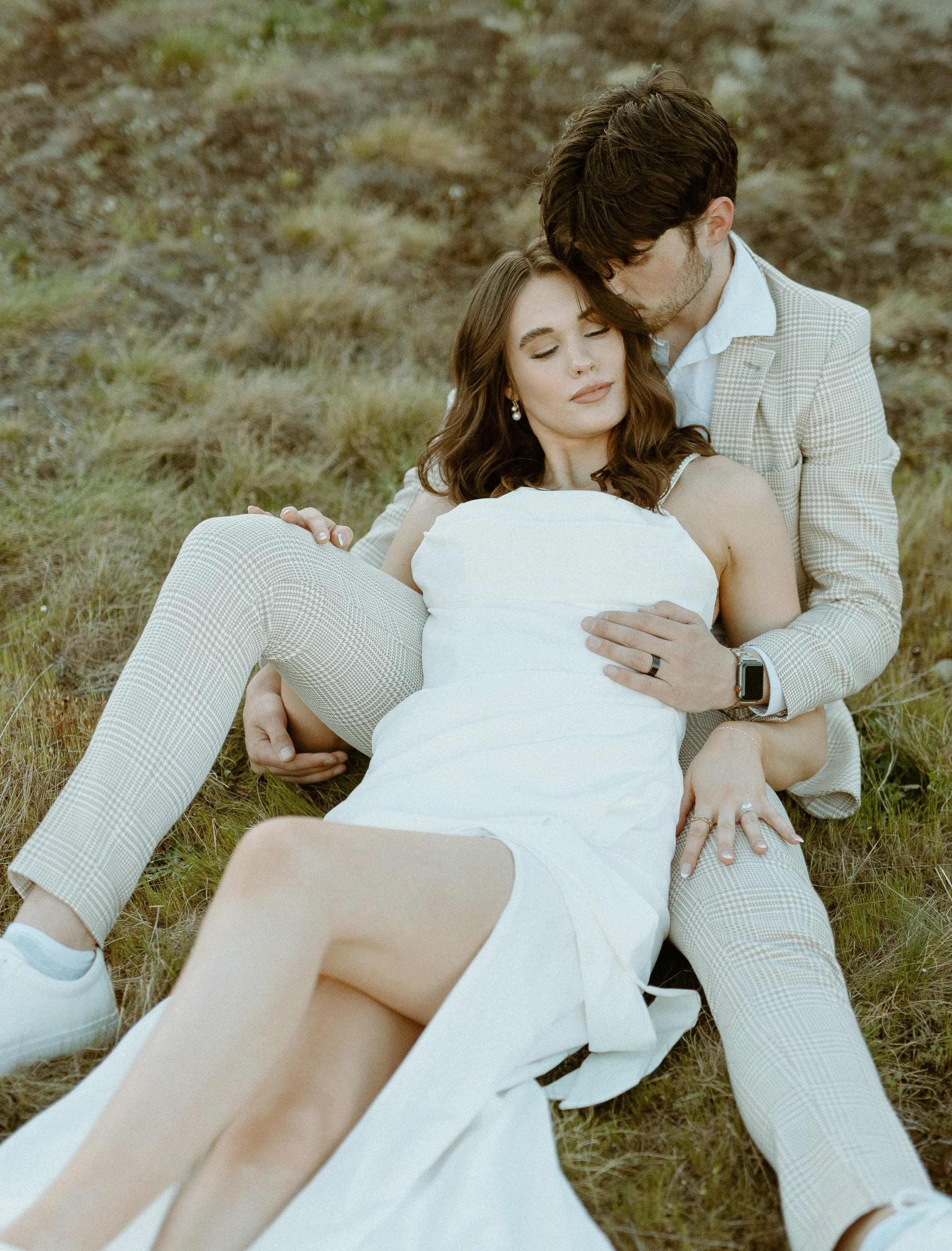 intimate bridal couple portrait sitting in grass during Chambers Bay styled shoot in Washington