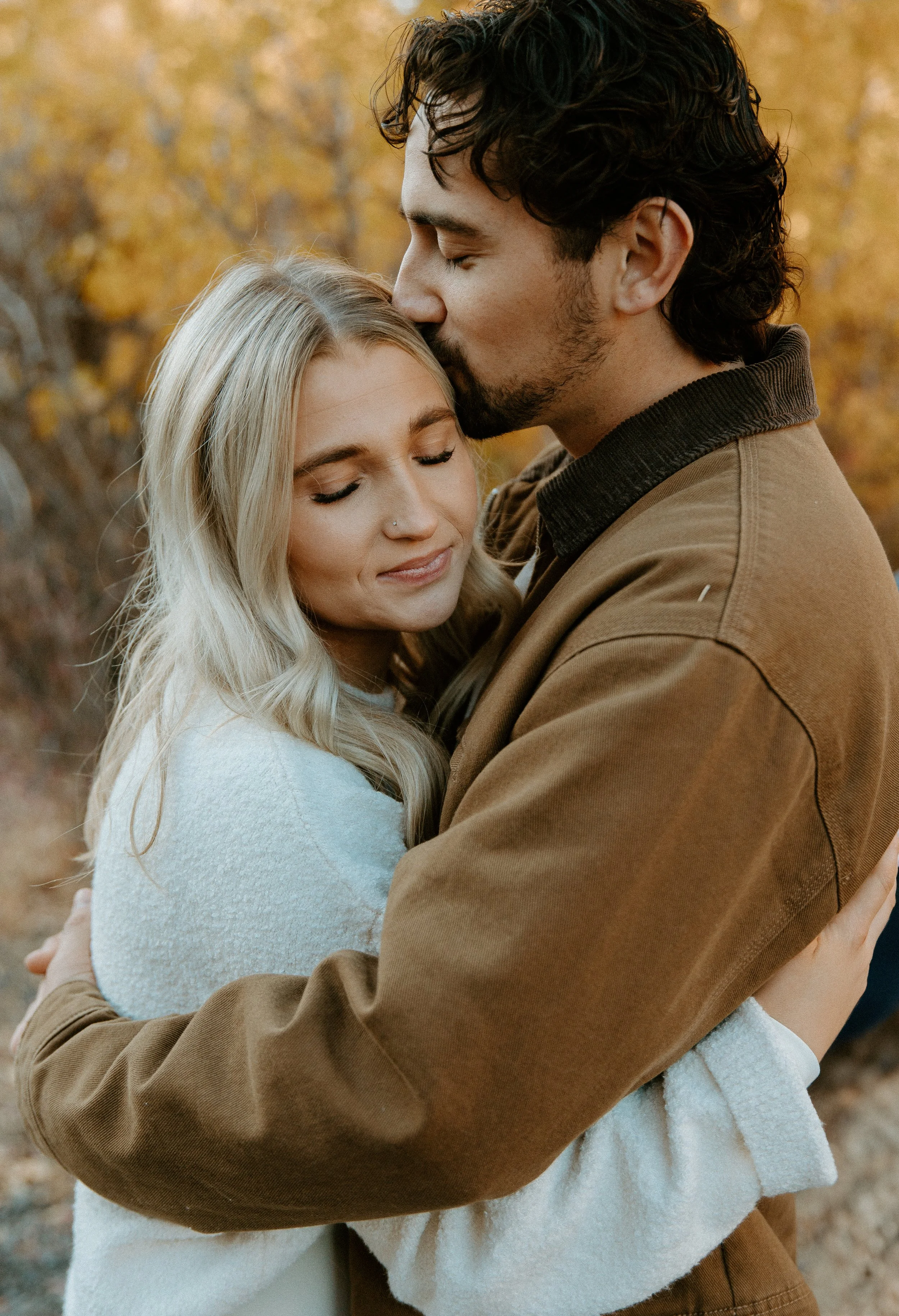 couple embracing during fall engagement session + Yakima Washington + golden tones