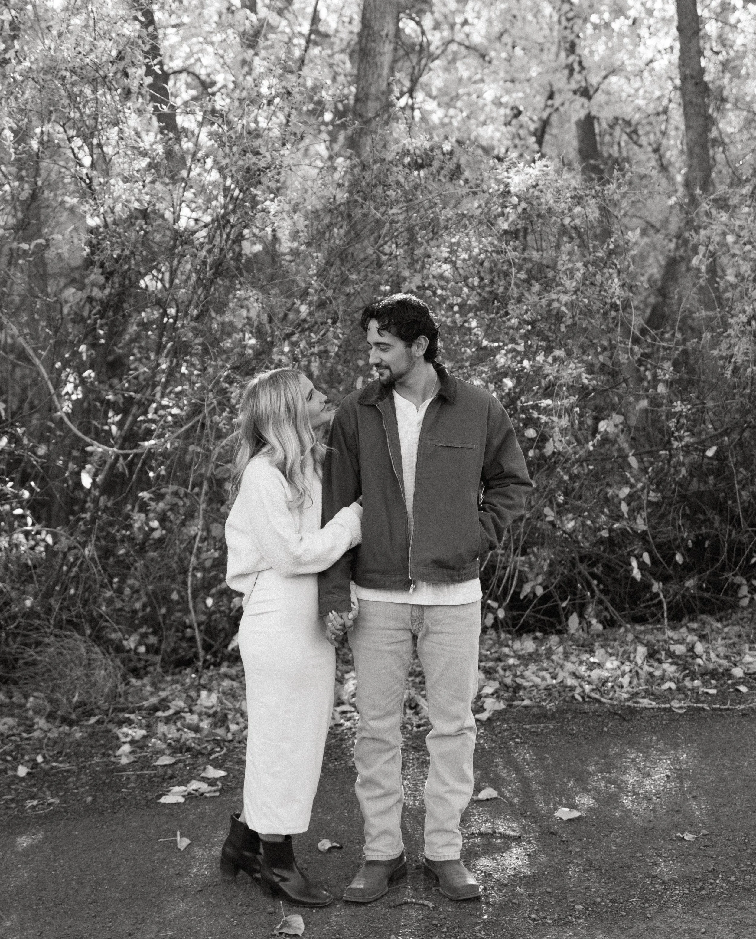couple holding hands during fall engagement session + Yakima Washington + black and white photo