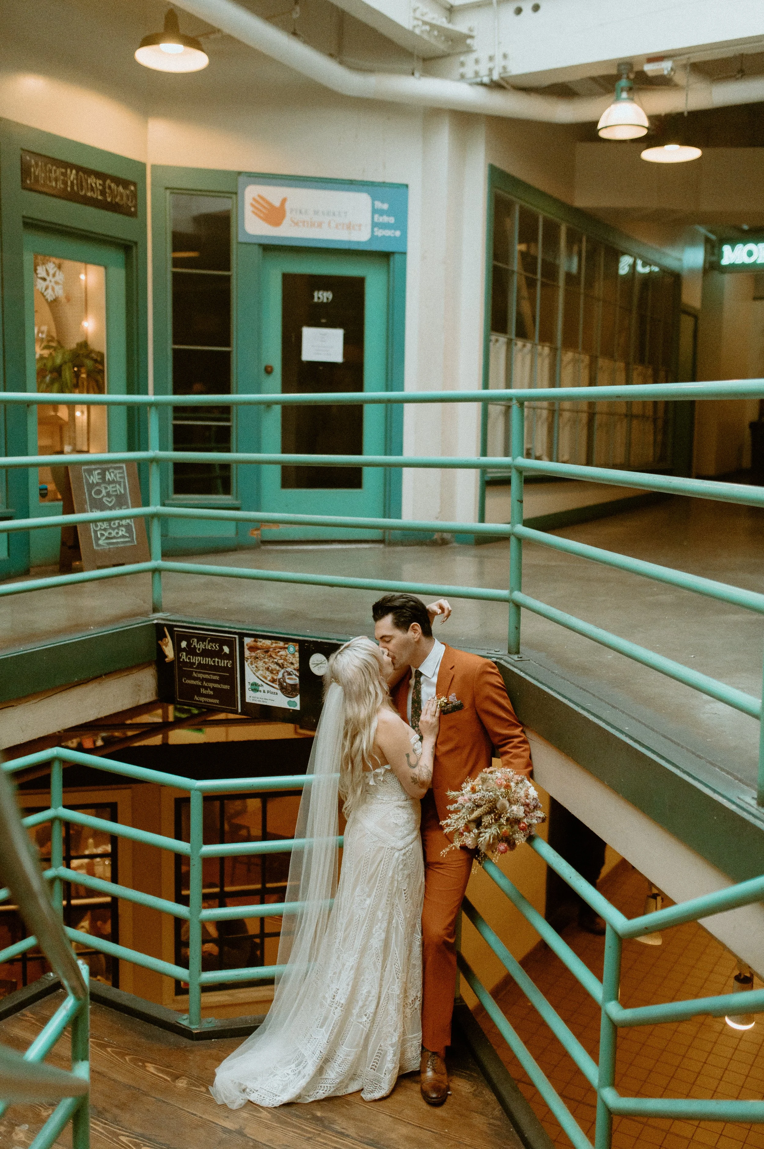 Bride and groom kissing on a staircase in a downtown Seattle building during their elopement