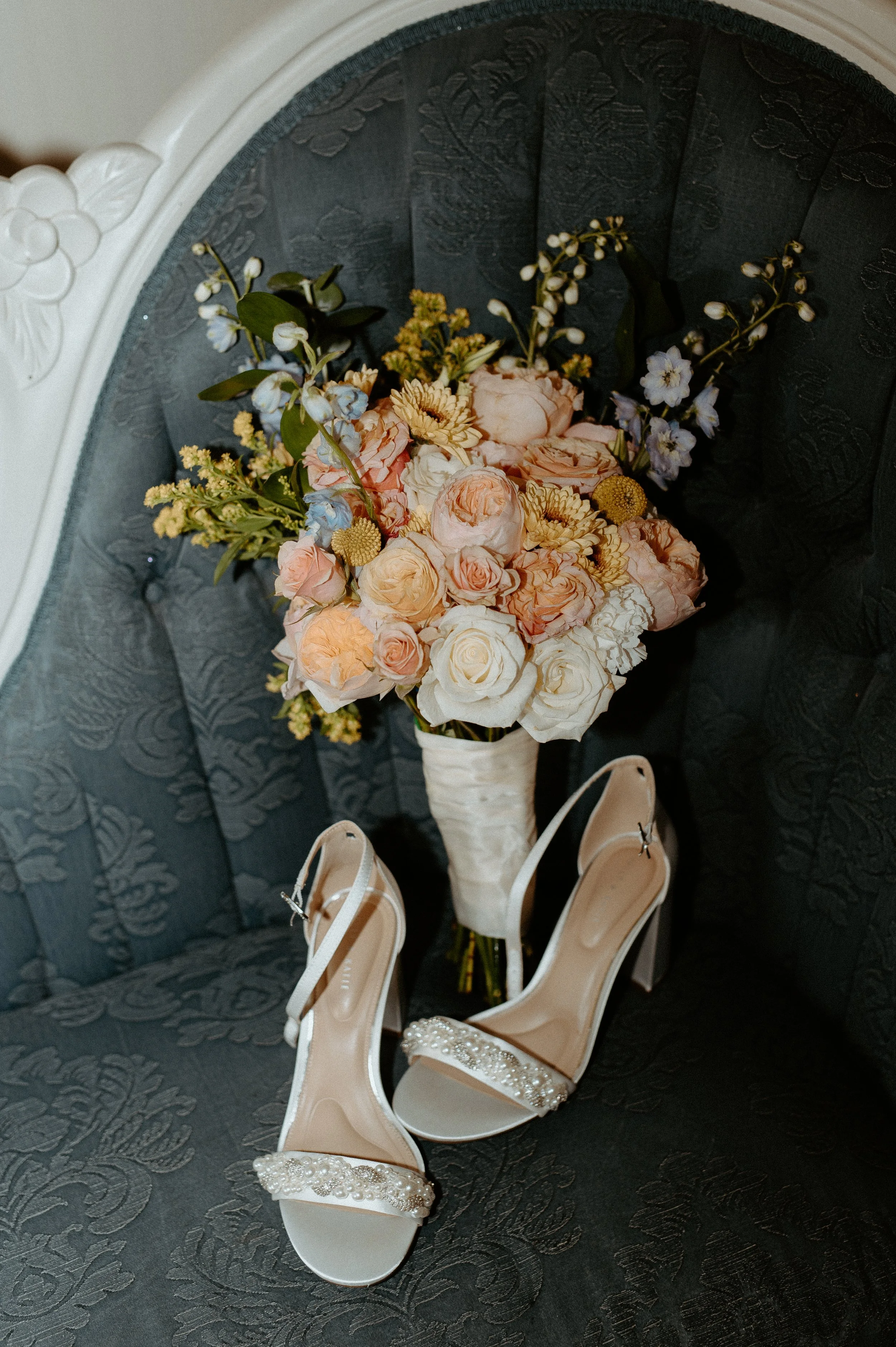 Bridal detail photo with wedding shoes and pastel bouquet at Kelley Farm wedding in Buckley Washington