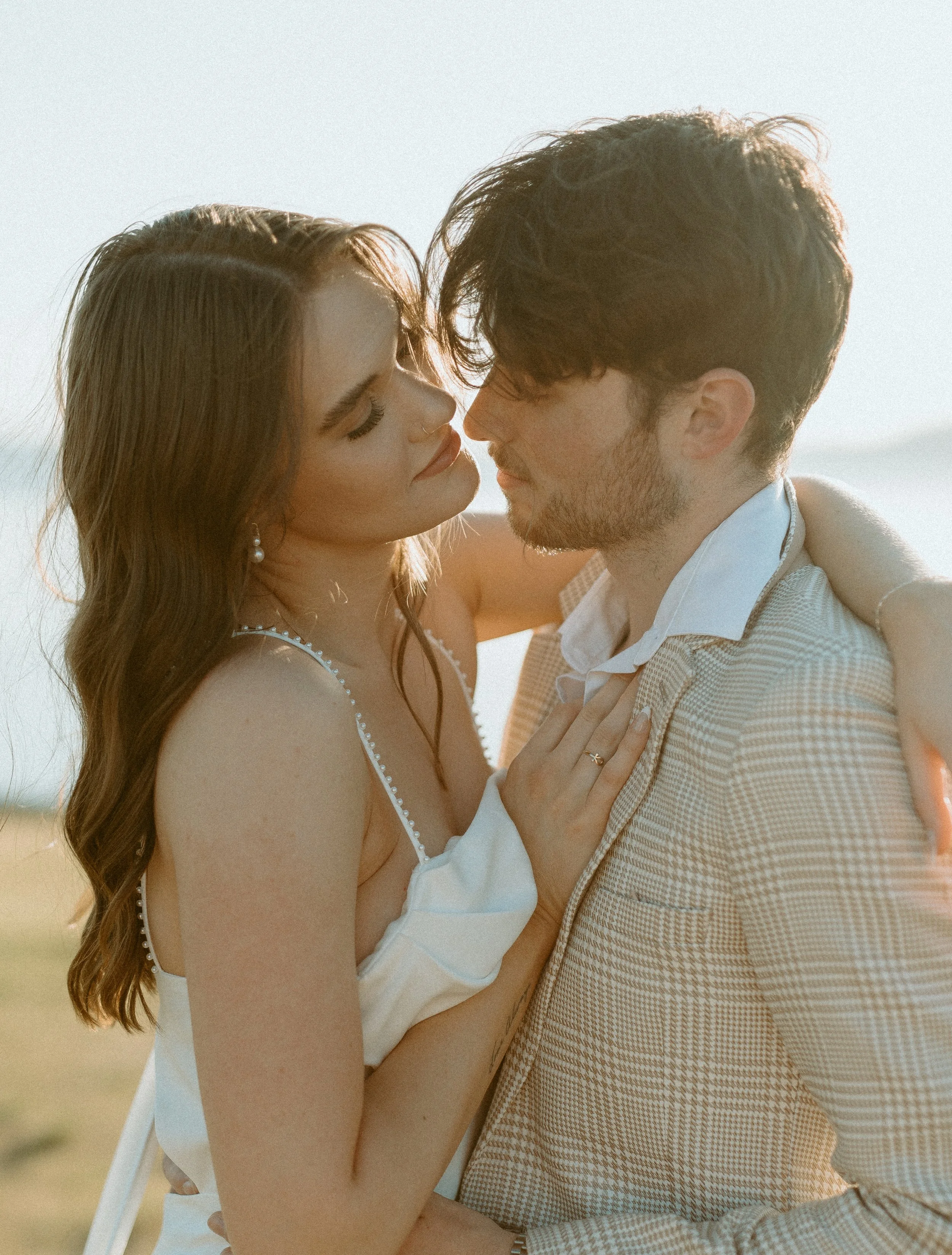 couple embracing during golden hour styled bridal shoot at Chambers Bay in Washington