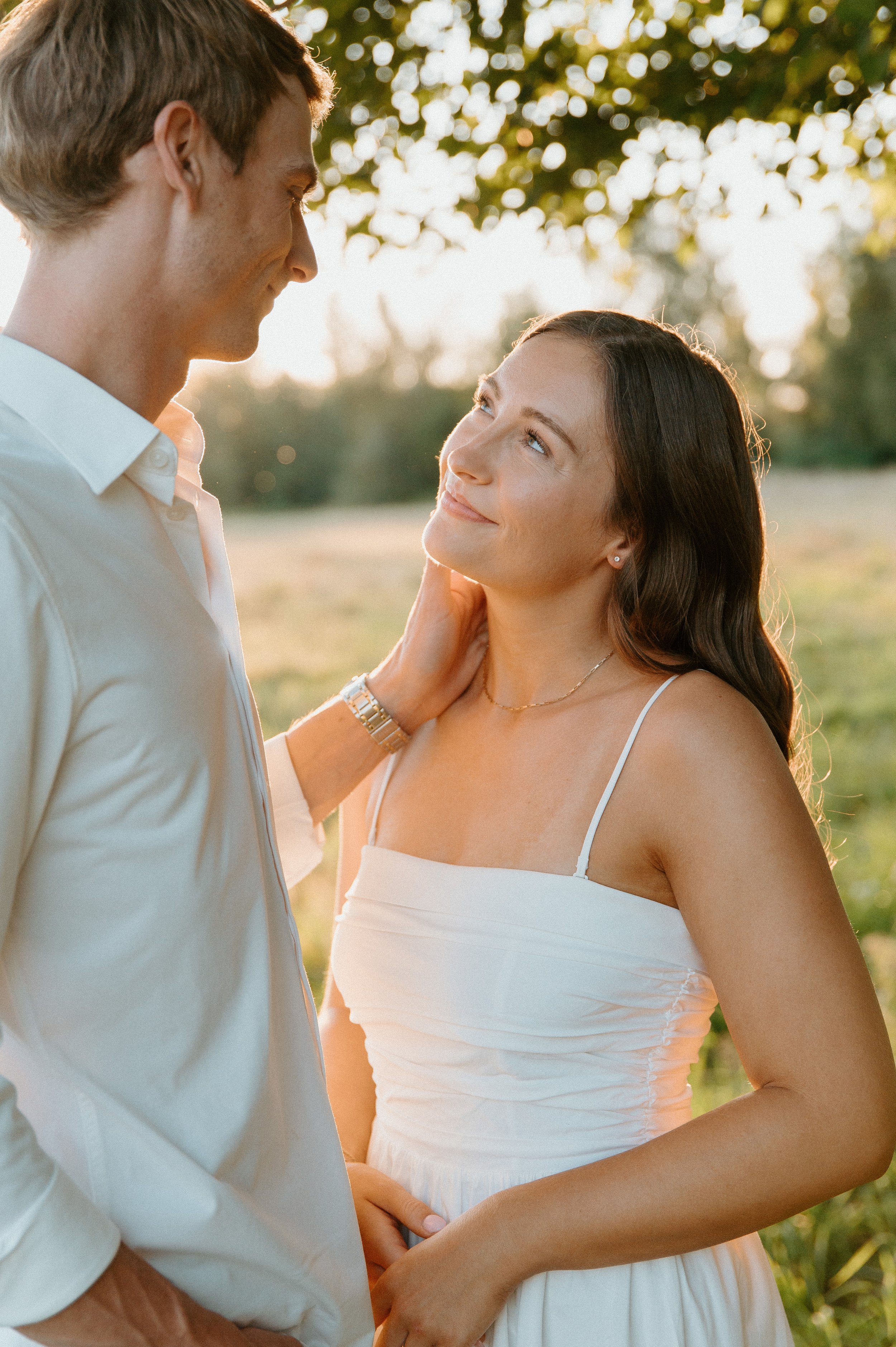 Engaged couple gazing at each other in warm golden hour light during their romantic North Bend engagement session