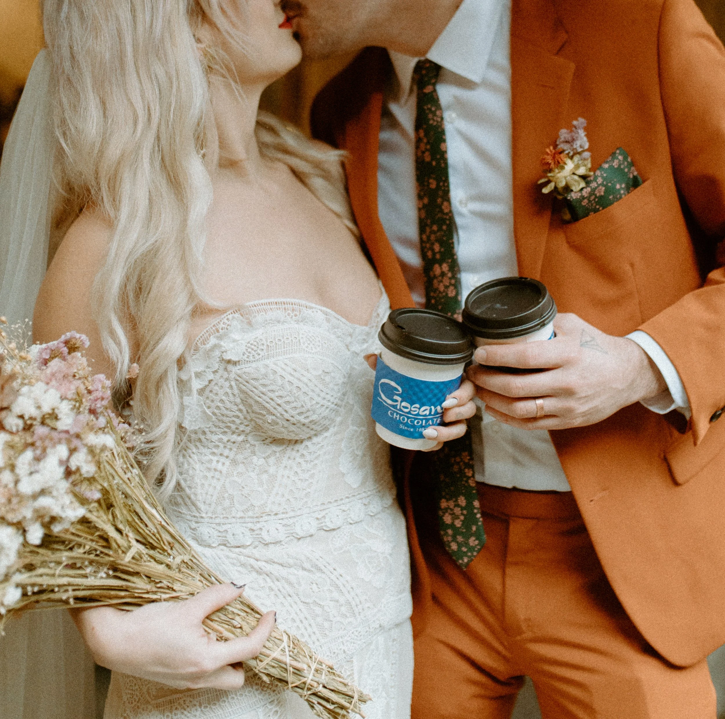 Bride and groom holding coffee cups during a cozy Seattle elopement near Pike Place