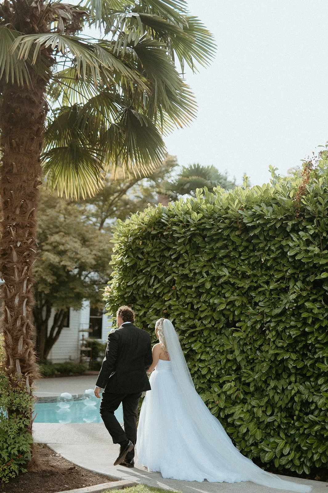 bride + and + groom + walking together + at + The Orting Manor wedding + in + the Pacific Northwest