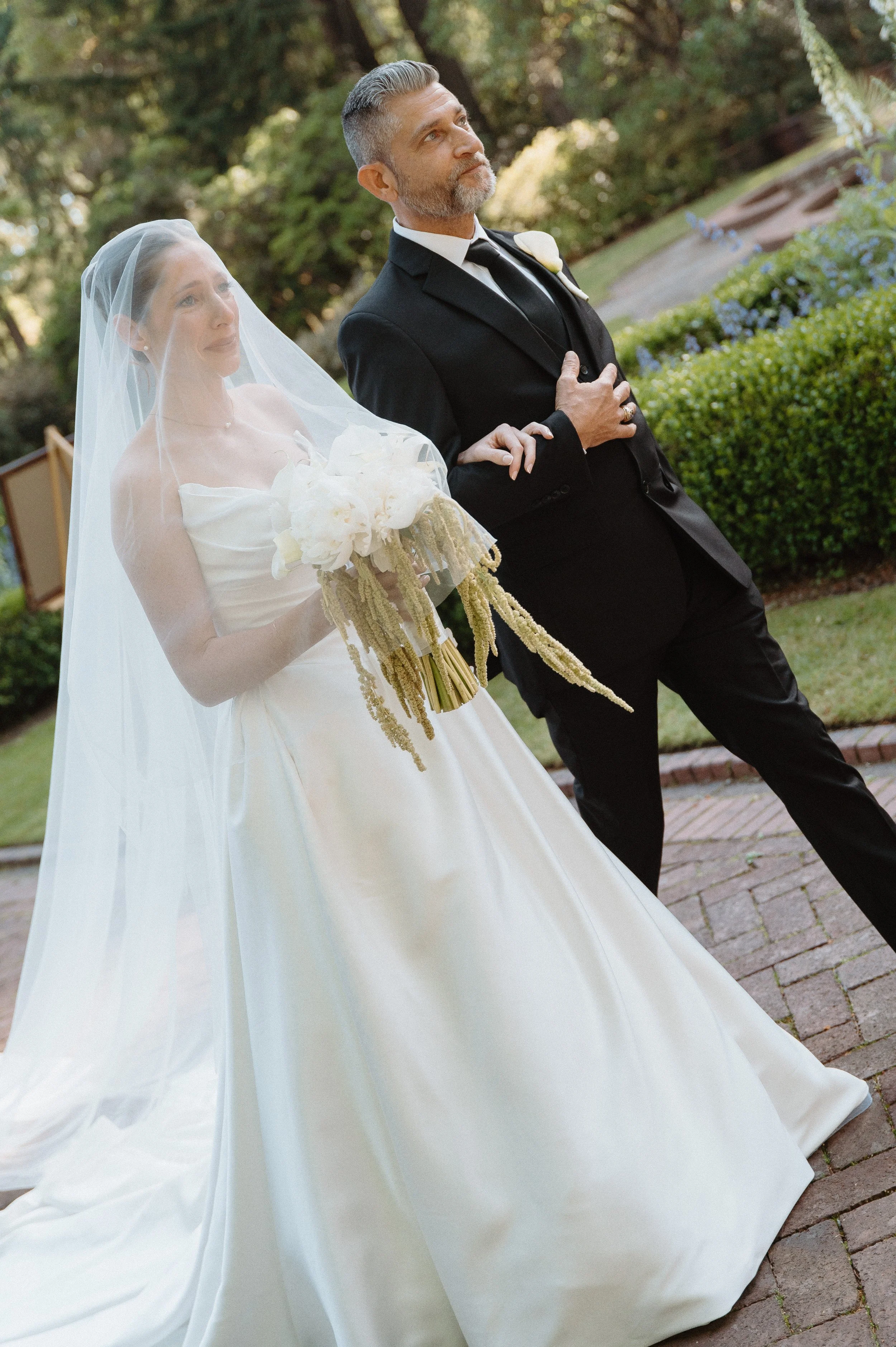 Elegant bridal portrait with cathedral veil at Lakewold Gardens in Lakewood, Washington.