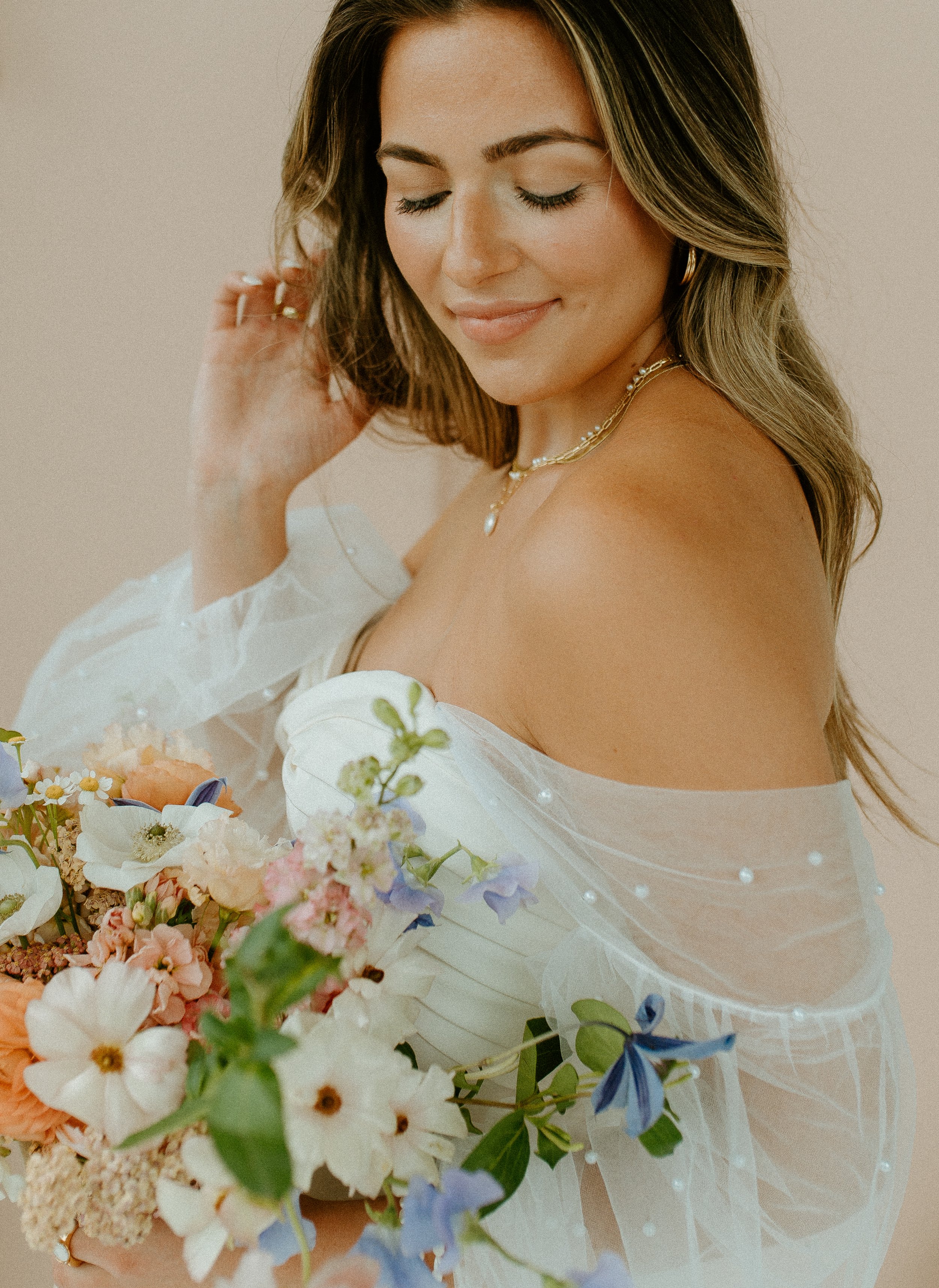 close up bridal portrait with off shoulder gown and colorful bouquet in Seattle