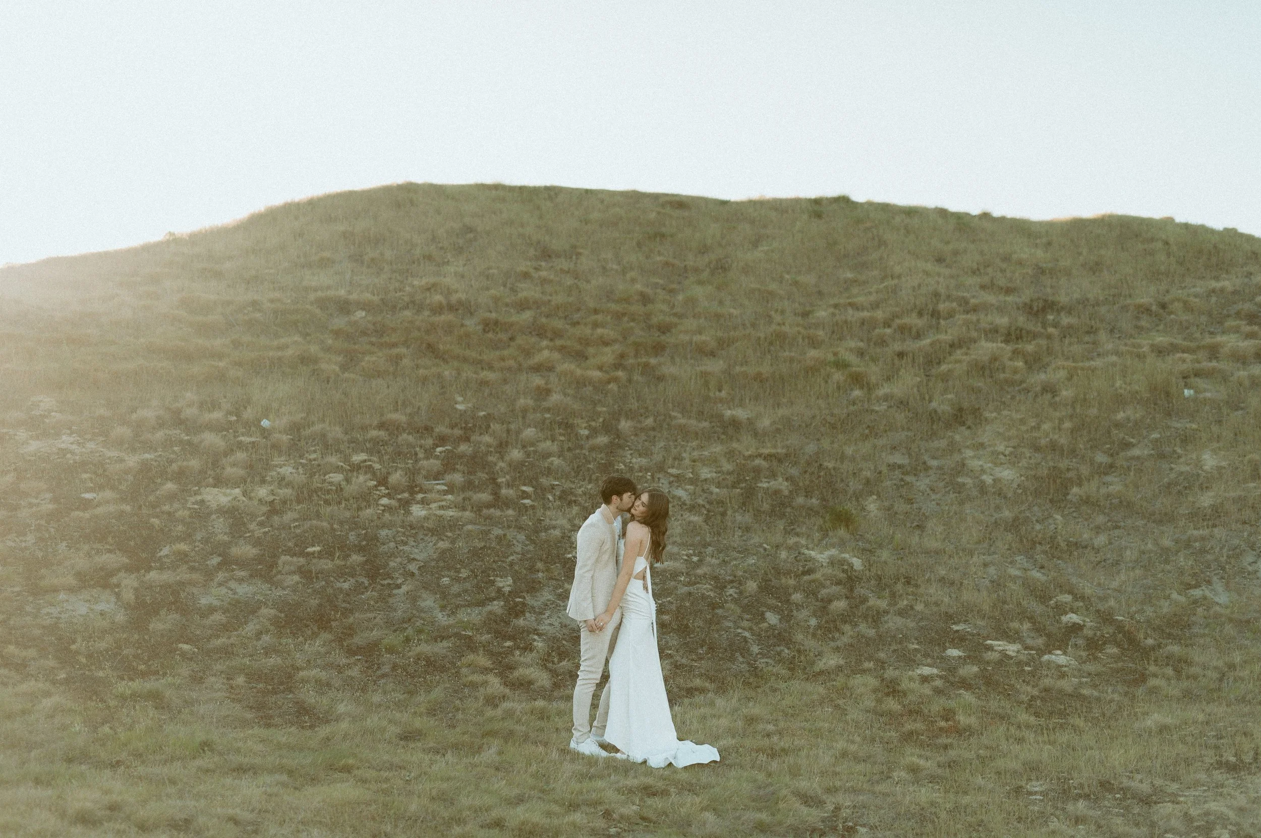 wide landscape shot of couple standing together at Chambers Bay styled bridal shoot