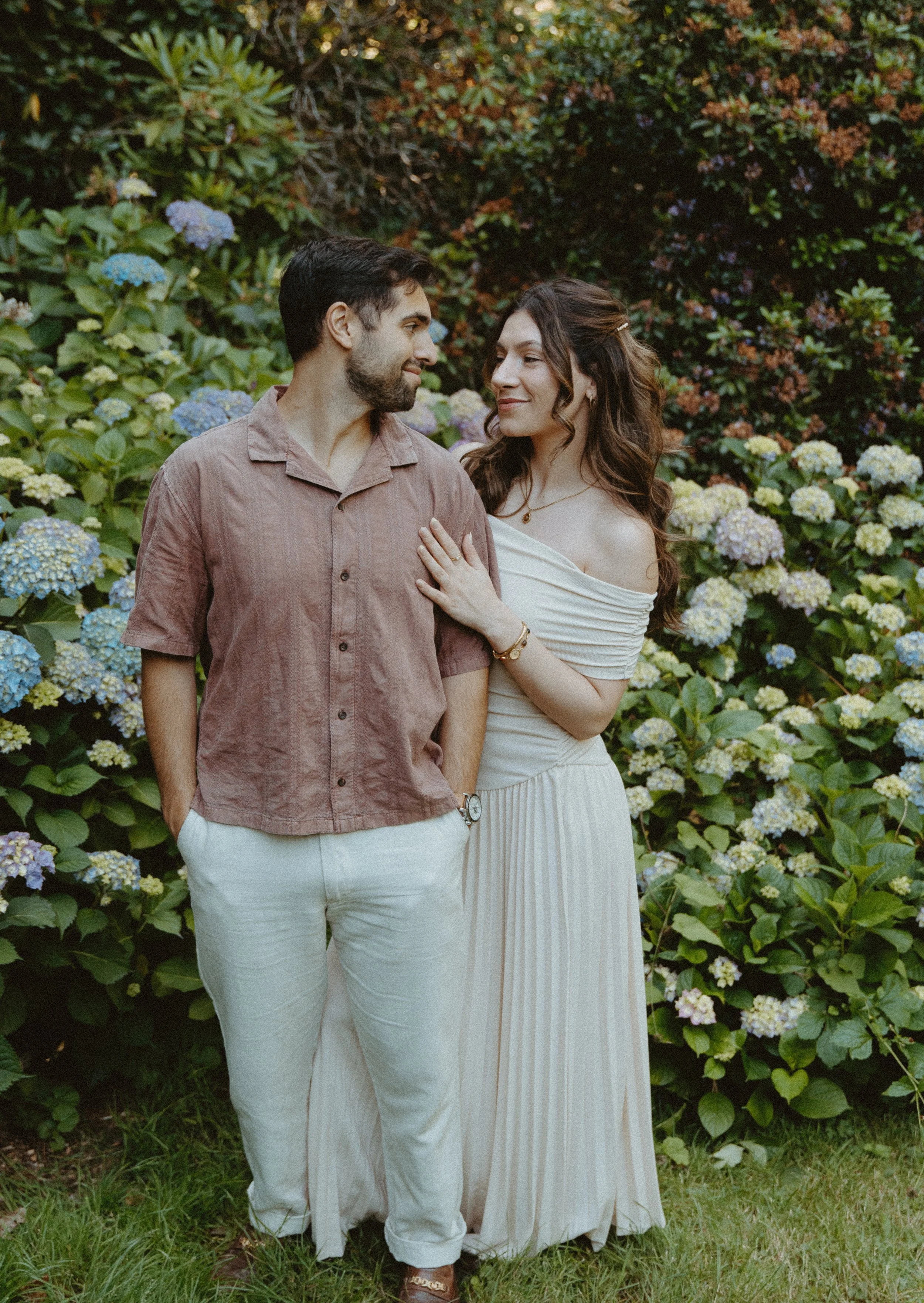 Couple embracing in a lush garden setting + emotional connection + Washington Park Arboretum Seattle + engagement portraits