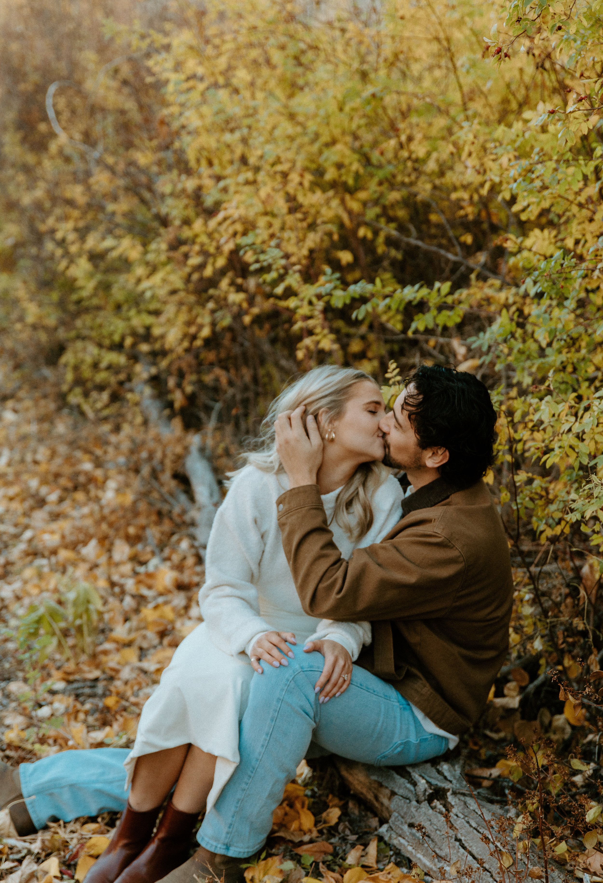 couple kissing during fall engagement session + Yakima Washington + golden leaves
