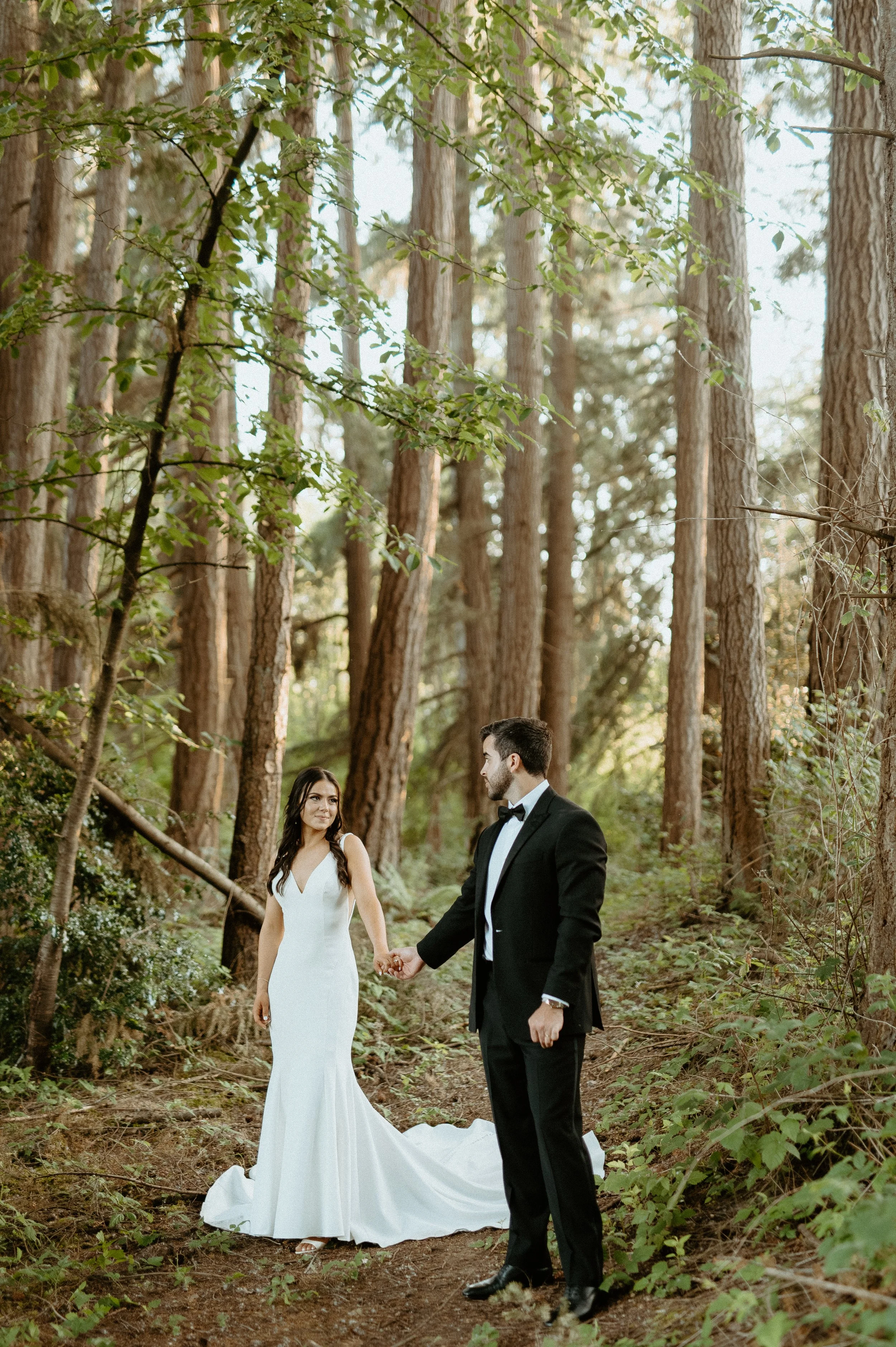 Bride and groom holding hands in a forest setting + outdoor wedding portraits + Pacific Northwest wedding + Woodinville wedding