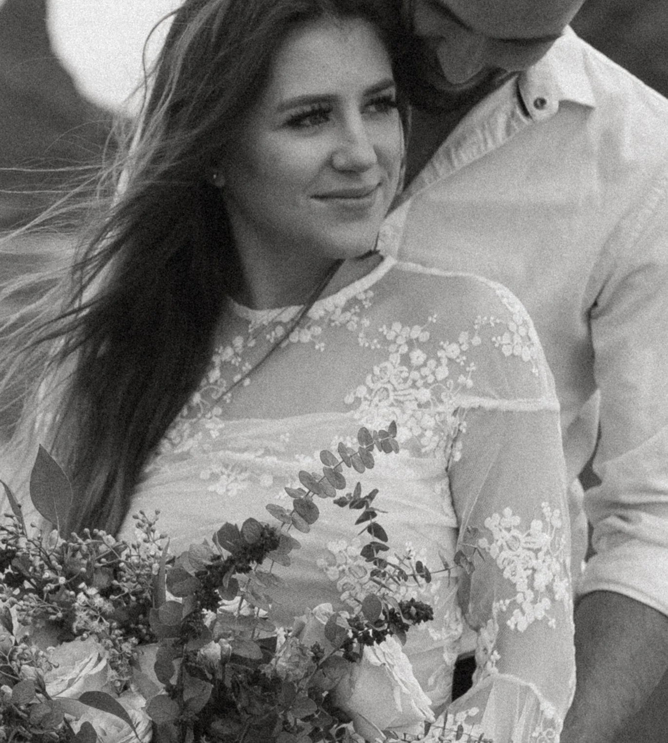 Black and white close up portrait of bride and groom on Cannon Beach with windblown hair and romantic coastal vibes