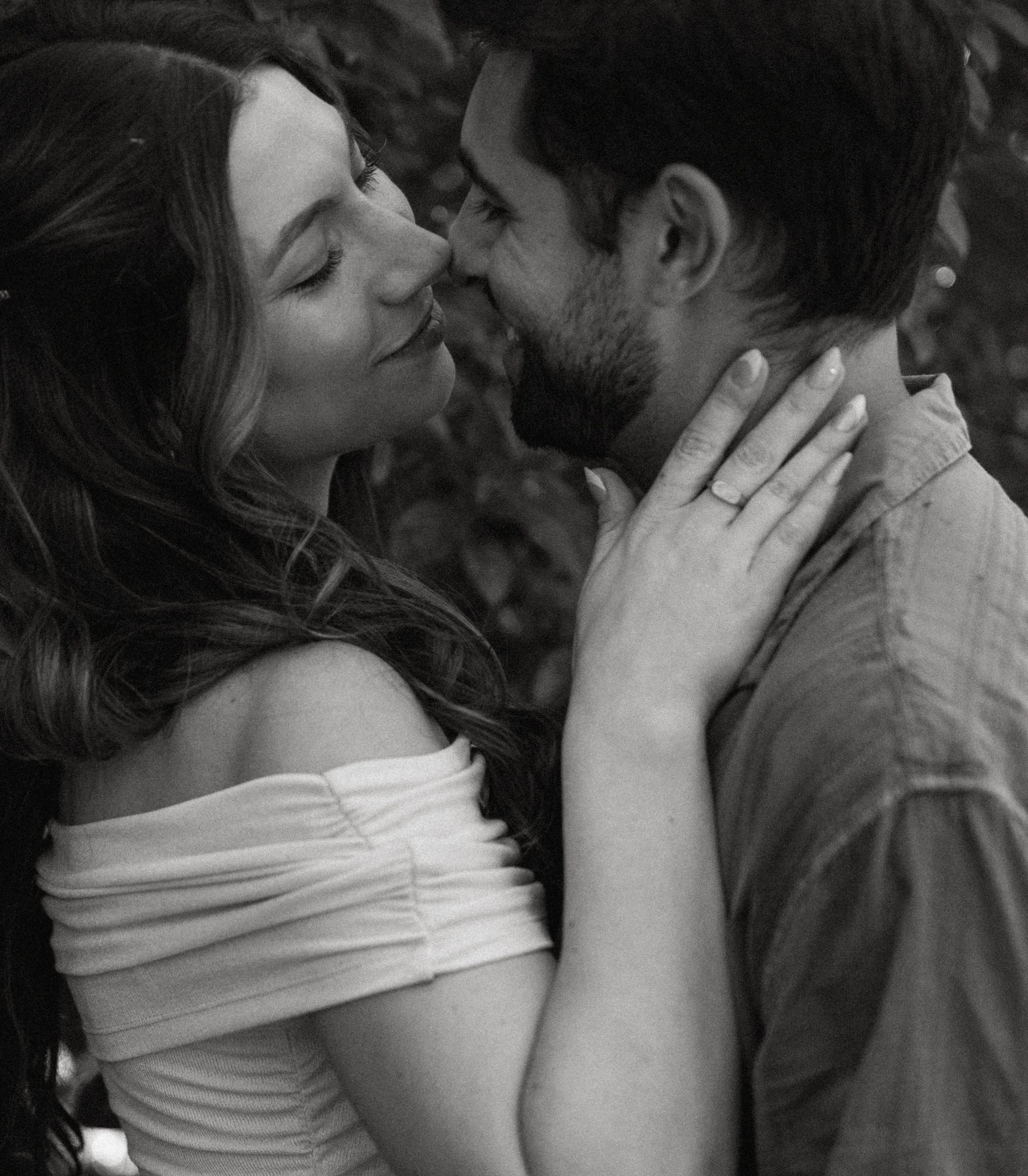 Close-up of couple leaning in together + intimate connection + Seattle engagement photographer + outdoor garden setting