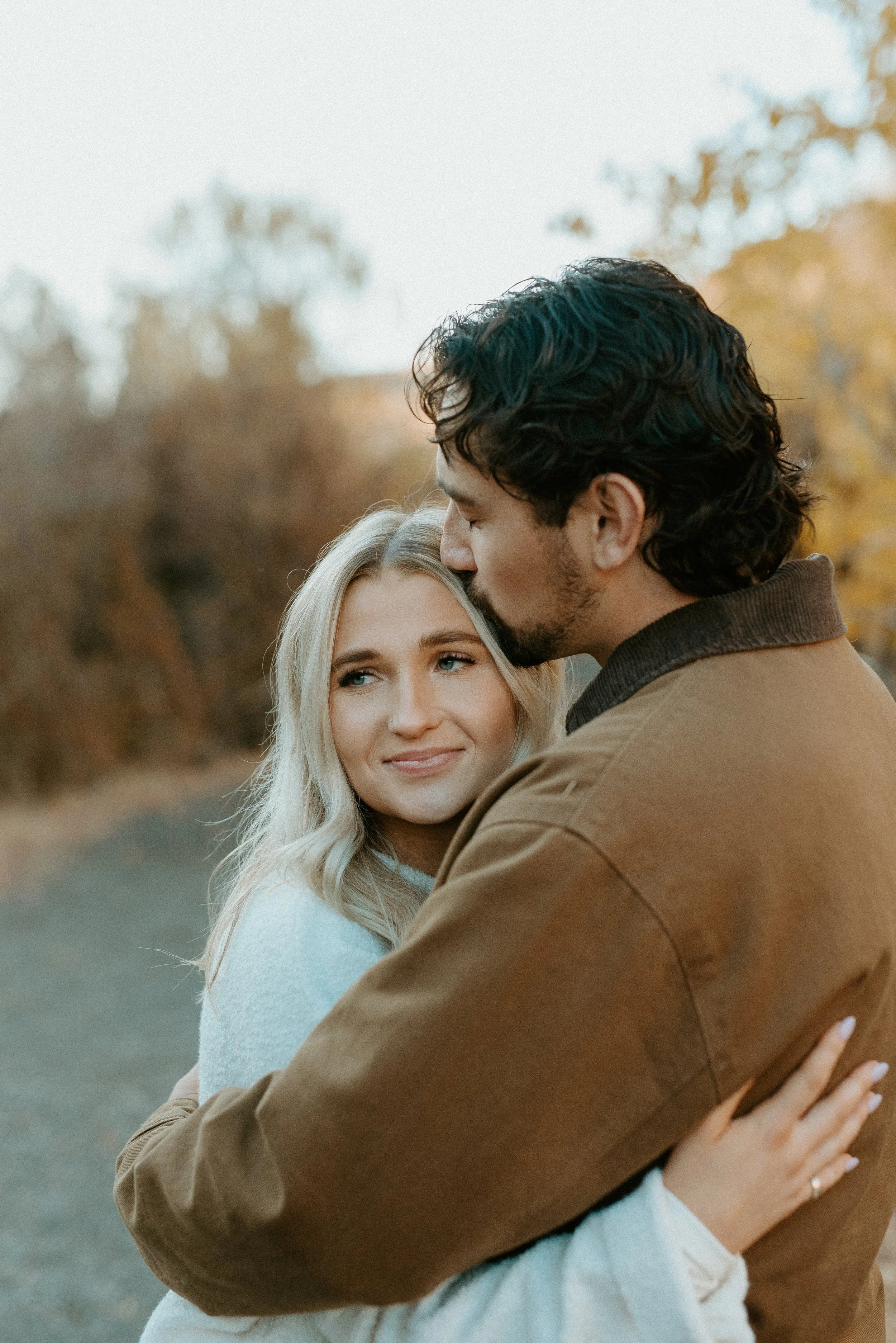 intimate fall engagement moment + couple embracing + Yakima Washington golden tones