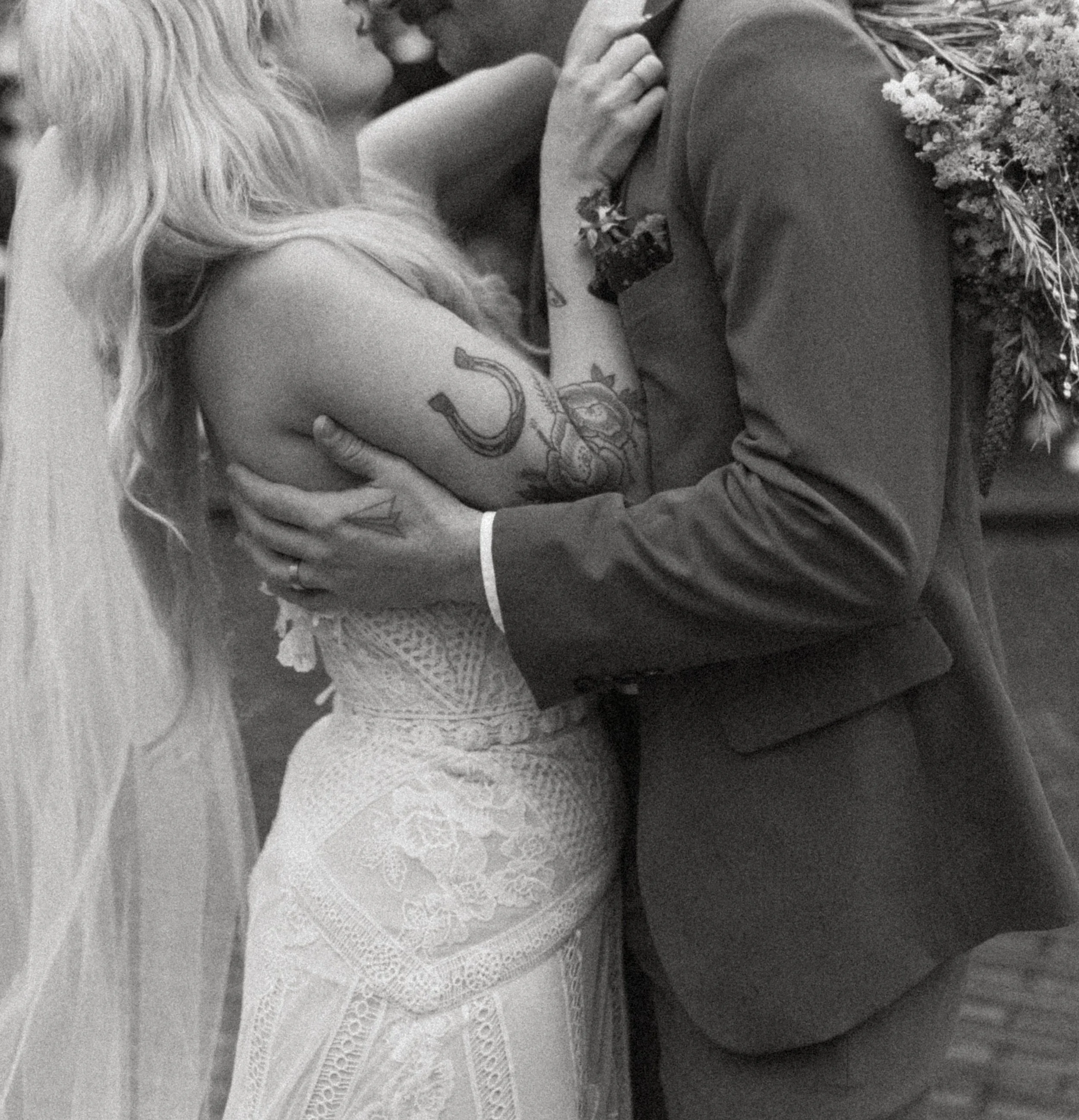 Close-up of bride and groom kissing with bouquet during a Seattle city elopement