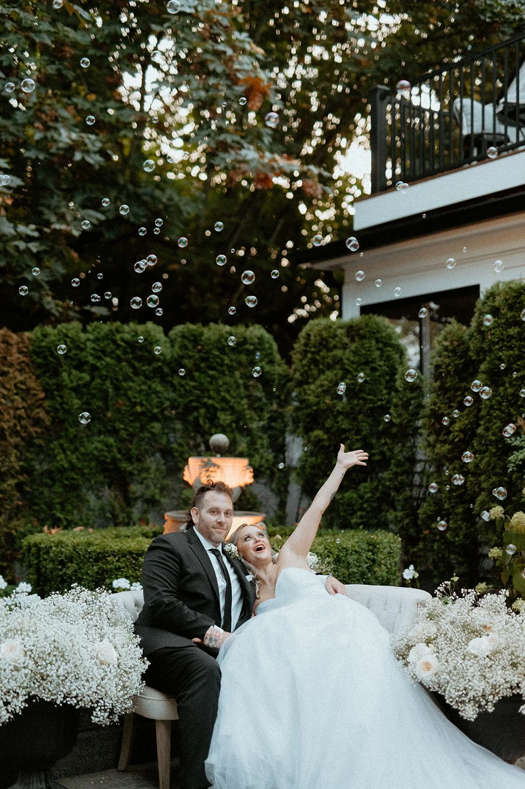 bride + and + groom + celebrating + with + bubbles + at + The Orting Manor + wedding + in + Orting WA + outdoor reception