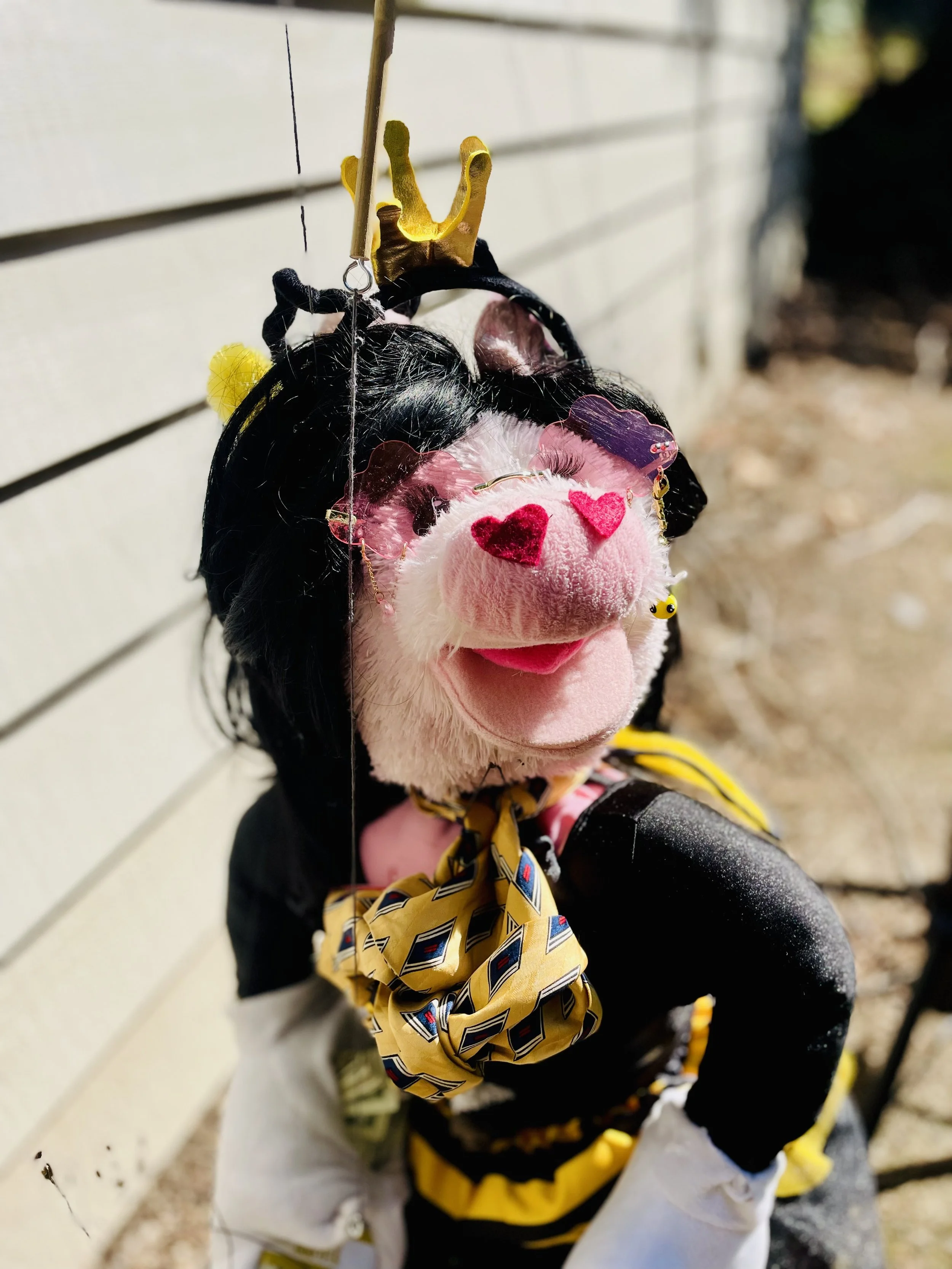 Billions with a "B"
A benevolent billionaire giving money. She also gives out wildflowers...and real actual money. She is also a ventriloquist dummy, She so rich she wears a Sasquatch on her belt!
