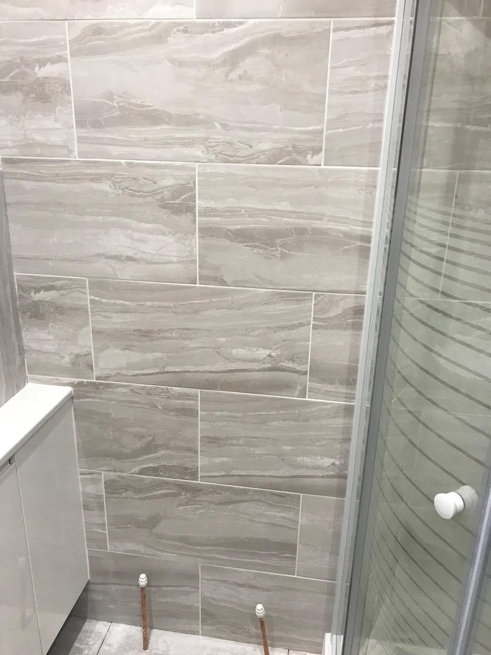 en-suite shower unit enclosure vanity units white kitchen island renovation plastering flooring electrical tiling metro modern stylish breakfast bar remodel design contractor rewire installer tradesman builder home improvement floor leveling worktop