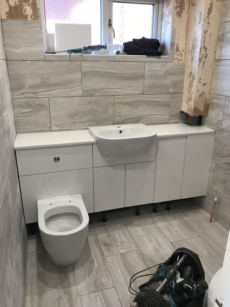 en-suite shower unit enclosure vanity units white kitchen island renovation plastering flooring electrical tiling metro modern stylish breakfast bar remodel design contractor rewire installer tradesman builder home improvement floor leveling worktop