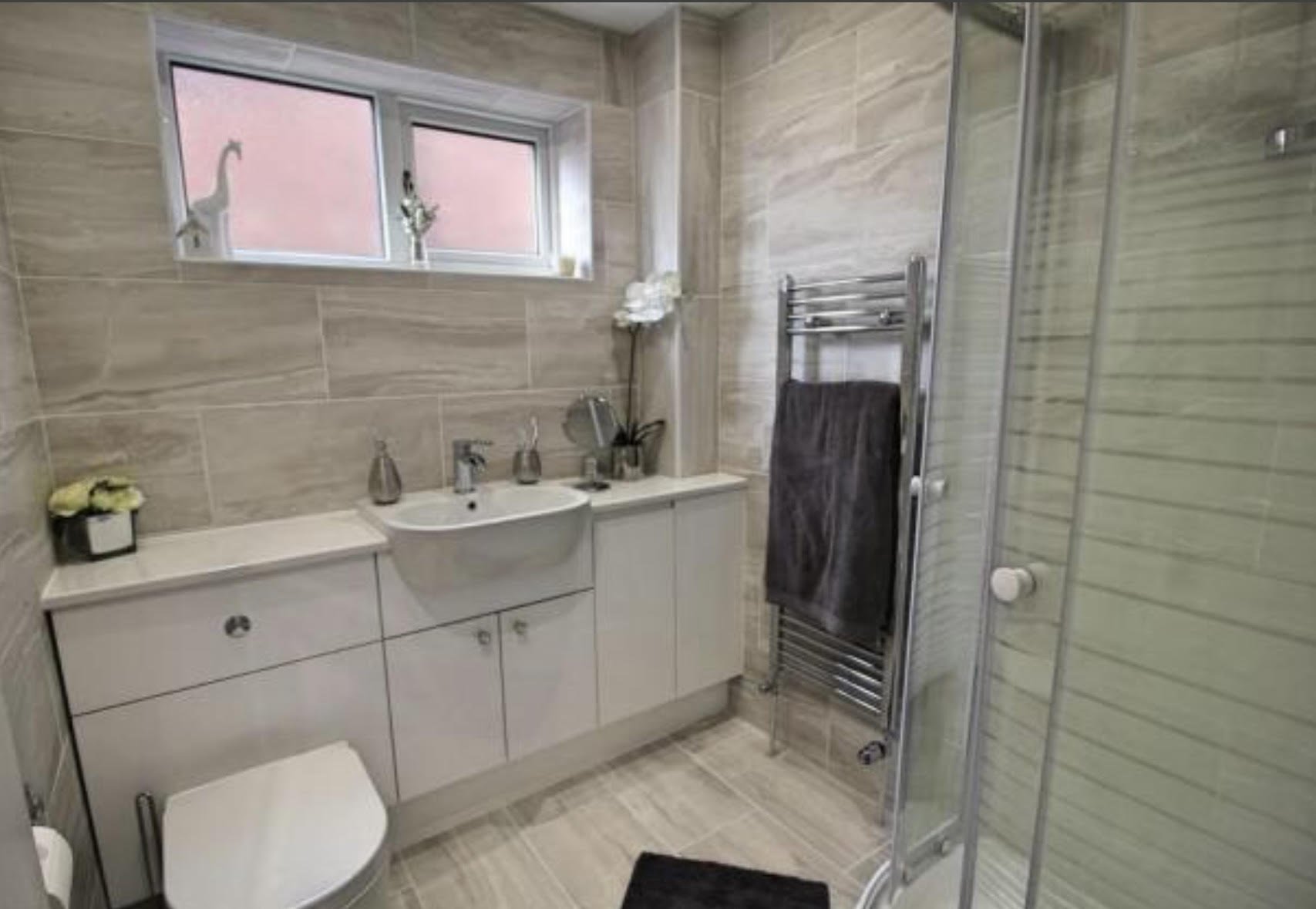 en-suite shower unit enclosure vanity units white kitchen island renovation plastering flooring electrical tiling metro modern stylish breakfast bar remodel design contractor rewire installer tradesman builder home improvement floor leveling worktop