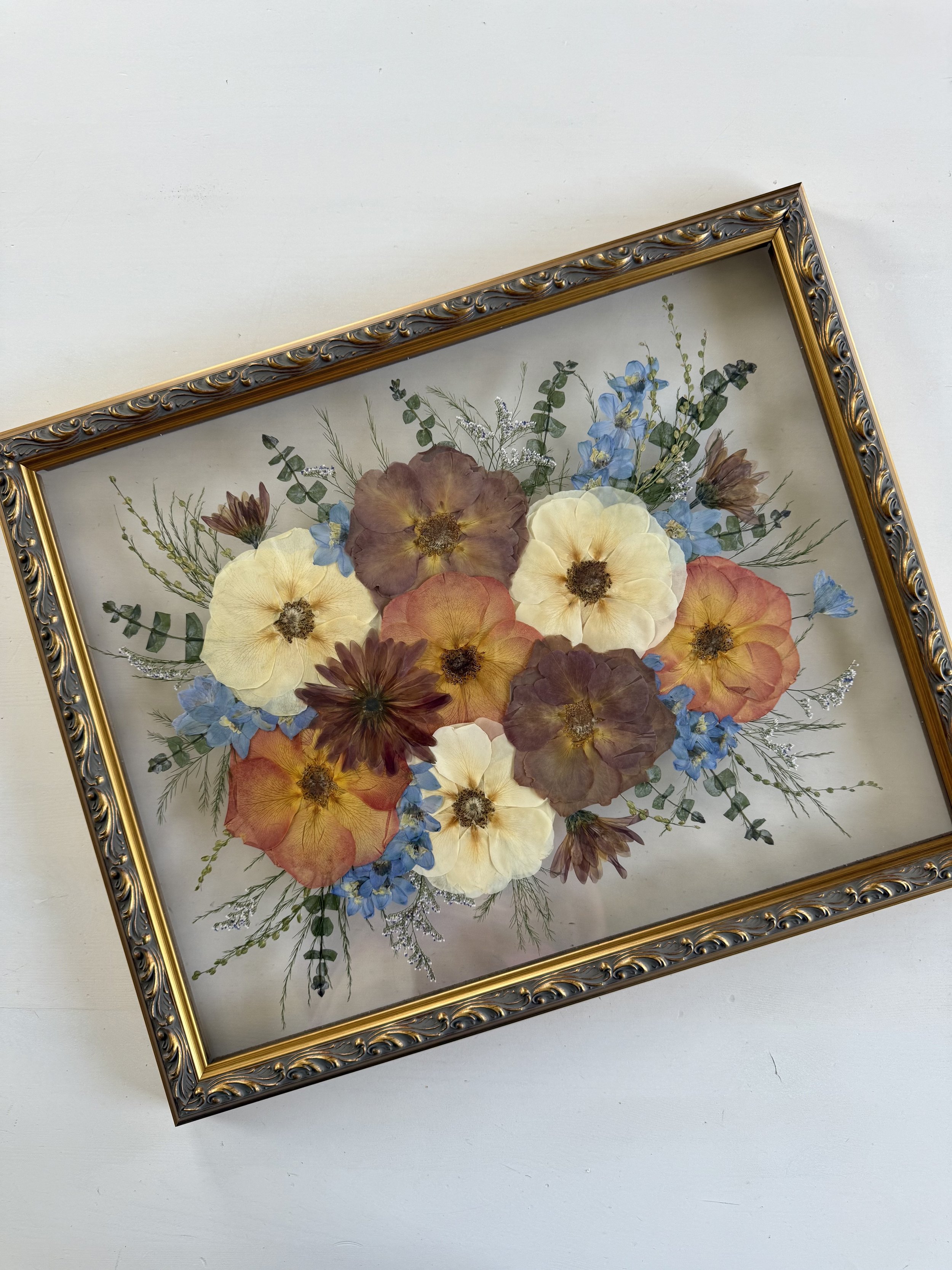 Framed and preserved mocha and white rose bridal bouquet in 16x20 inch size.