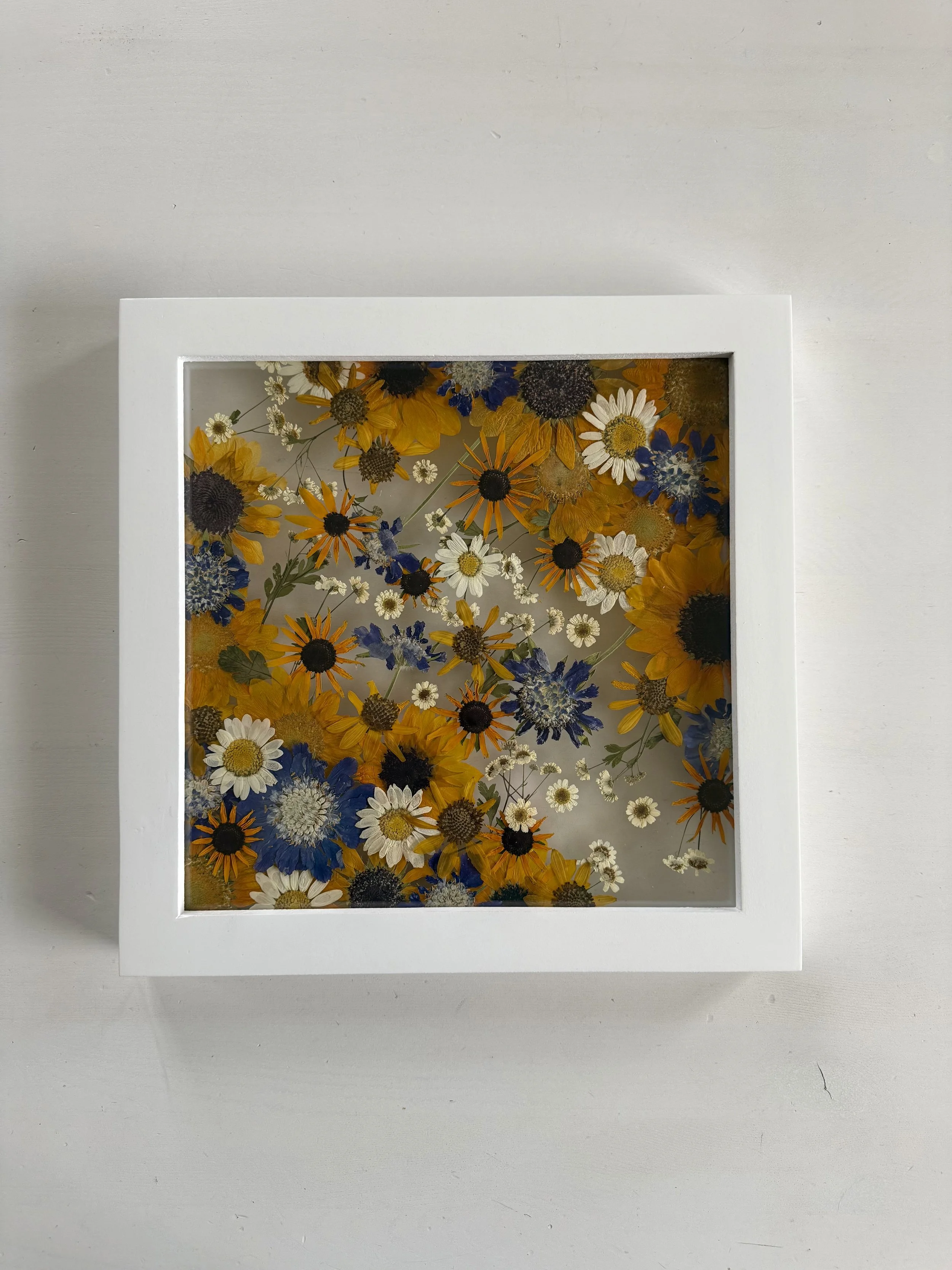 Pressed and framed wedding flowers.