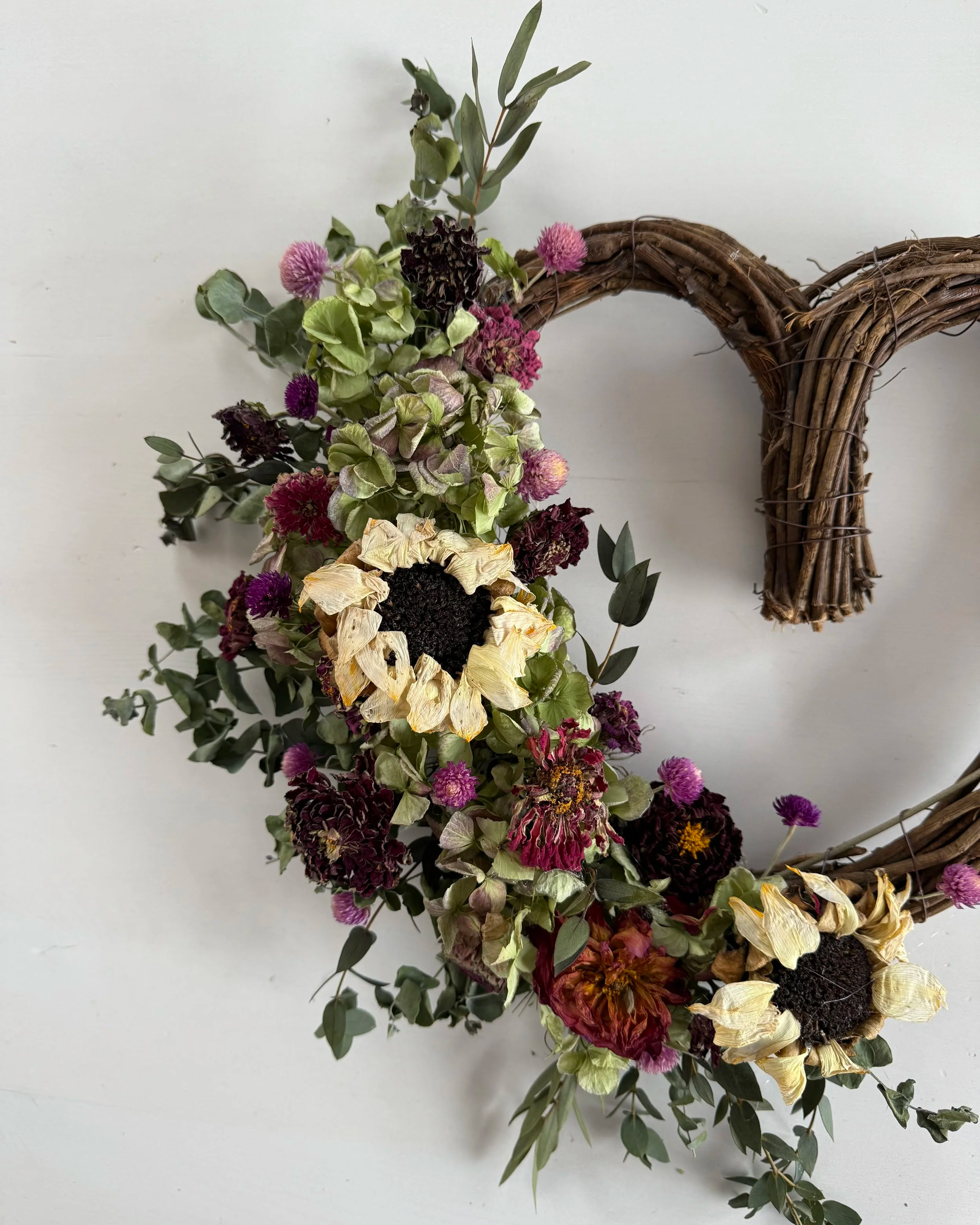 Use our locally grown dried flowers to add flair to a fresh evergreen wreath.