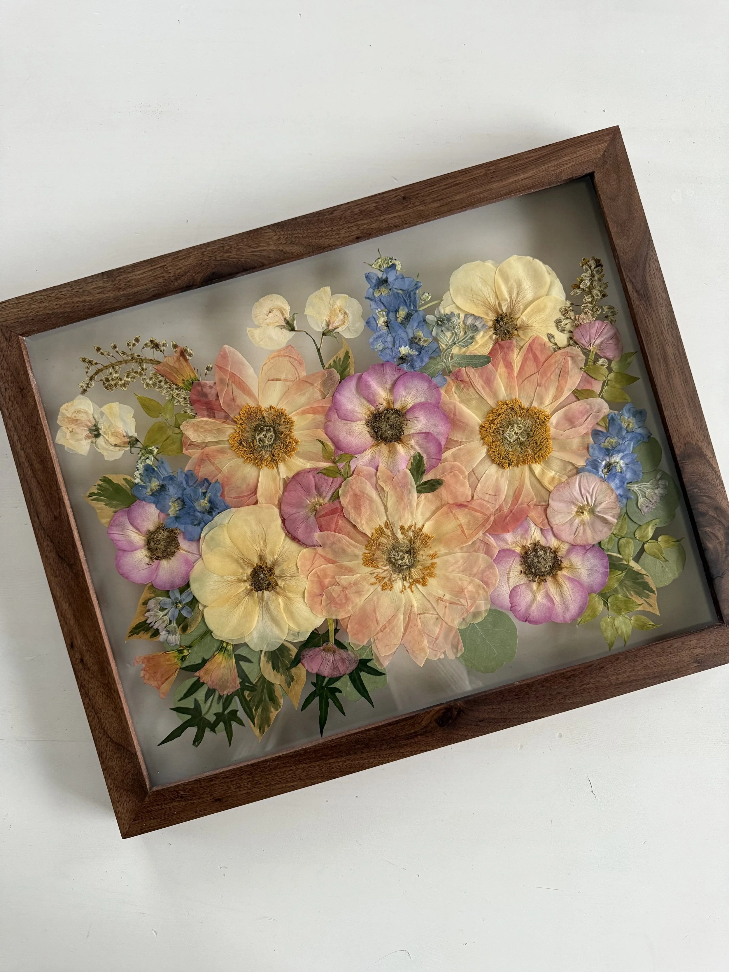 Seasonal summer bridal bouquet flowers, pressed and framed in a bouquet design.