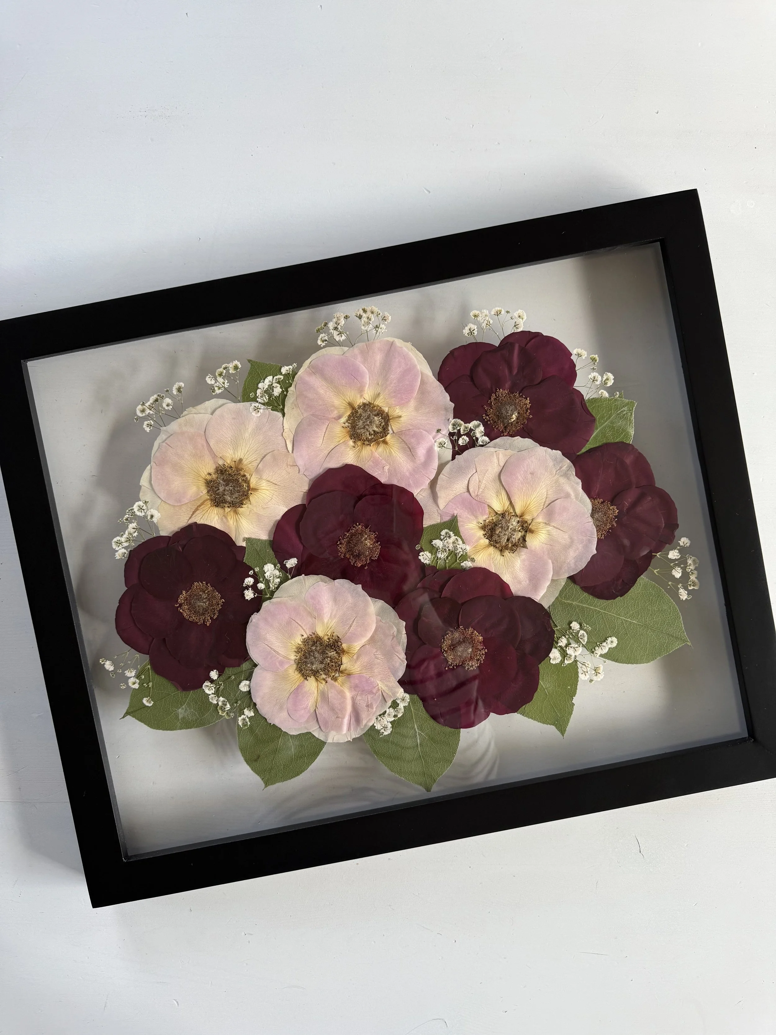 Framed and preserved pink and red rose bridal bouquet in 16x20 inch size.