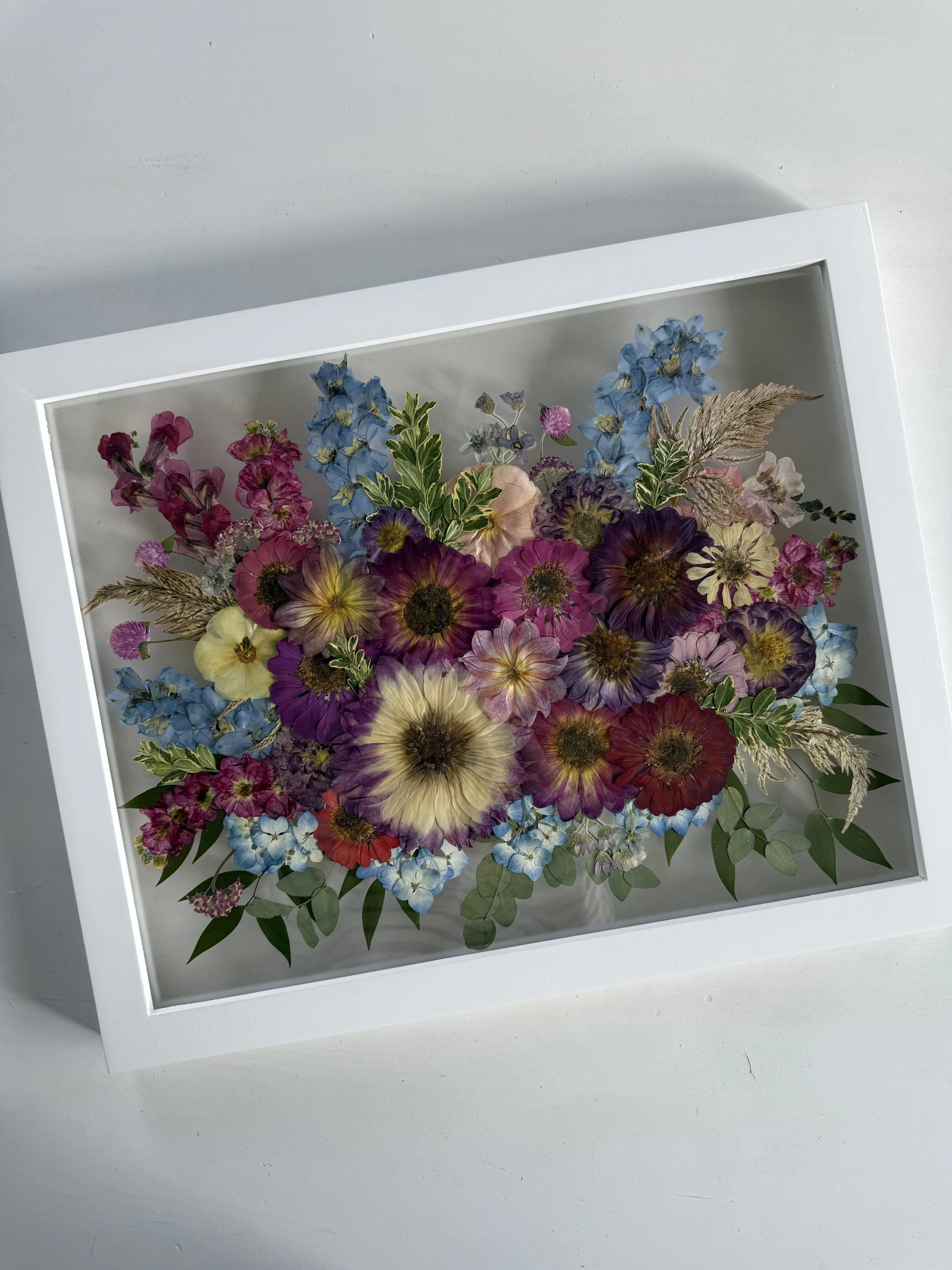 Framed and preserved dahlia and summer flower bridal bouquet in 16x20 inch size.