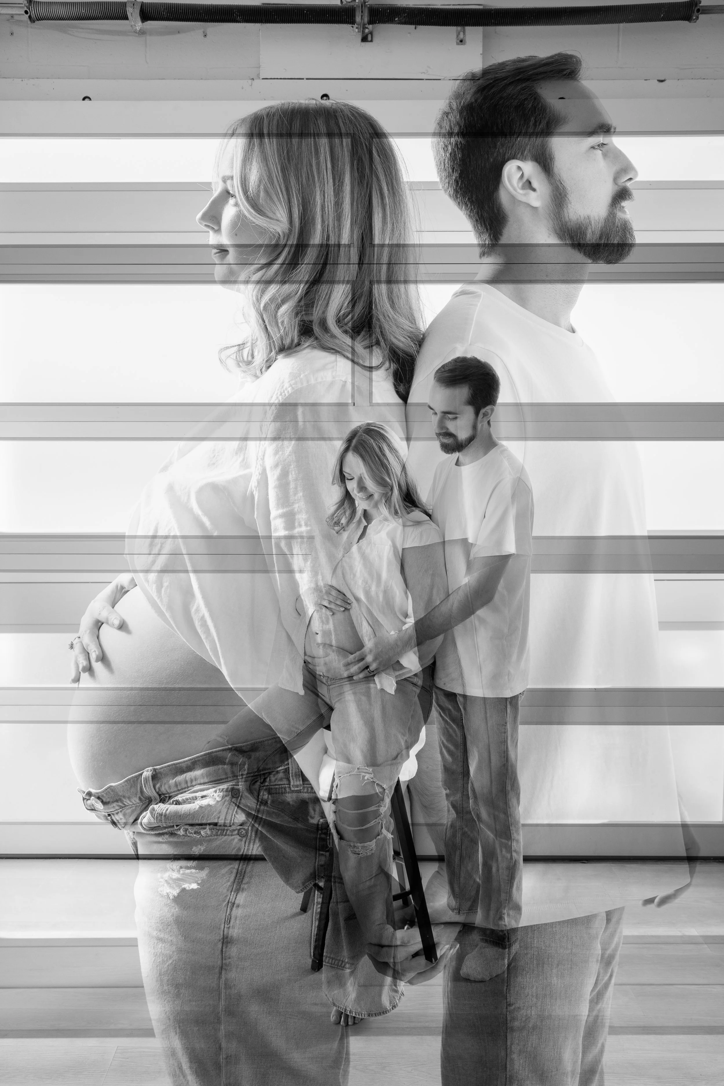 A black and white photograph of a couple, with a layered, overlapping effect. The woman is pregnant, and they are both facing sideways, with the woman looking down and the man looking forward. The woman is wearing a loose shirt, and the man is in a t-shirt. The image has a artistic double exposure or collage style.