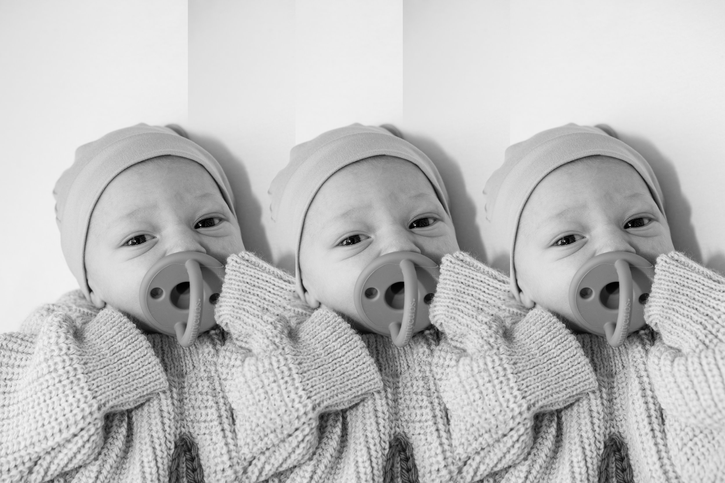 A black and white photo of a baby wearing a hat, a sweater, and a pacifier, lying against a plain background, repeated three times.