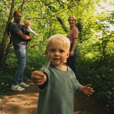 Little boy with weather in woodland with family