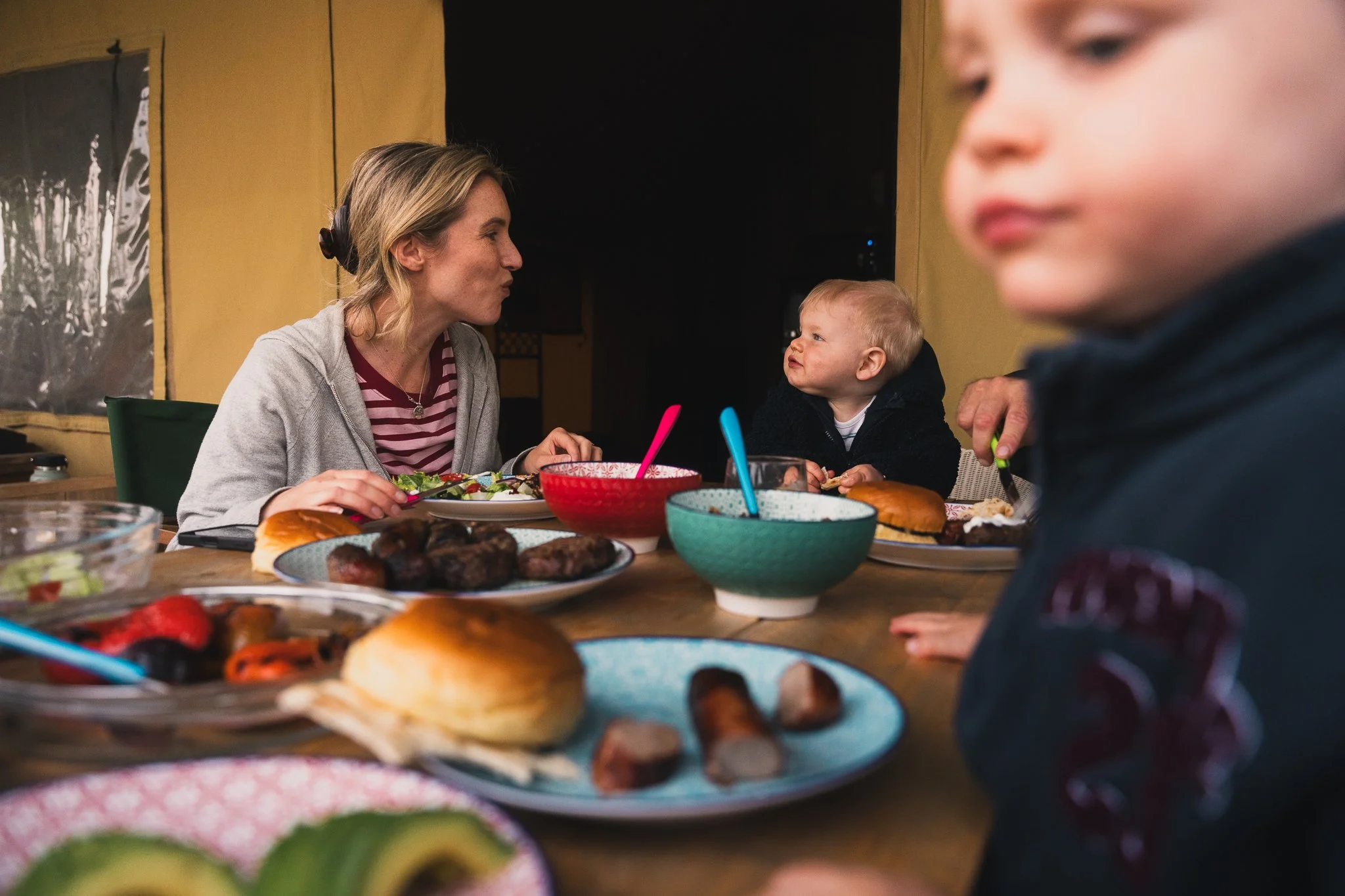 Family eating outside safari tent