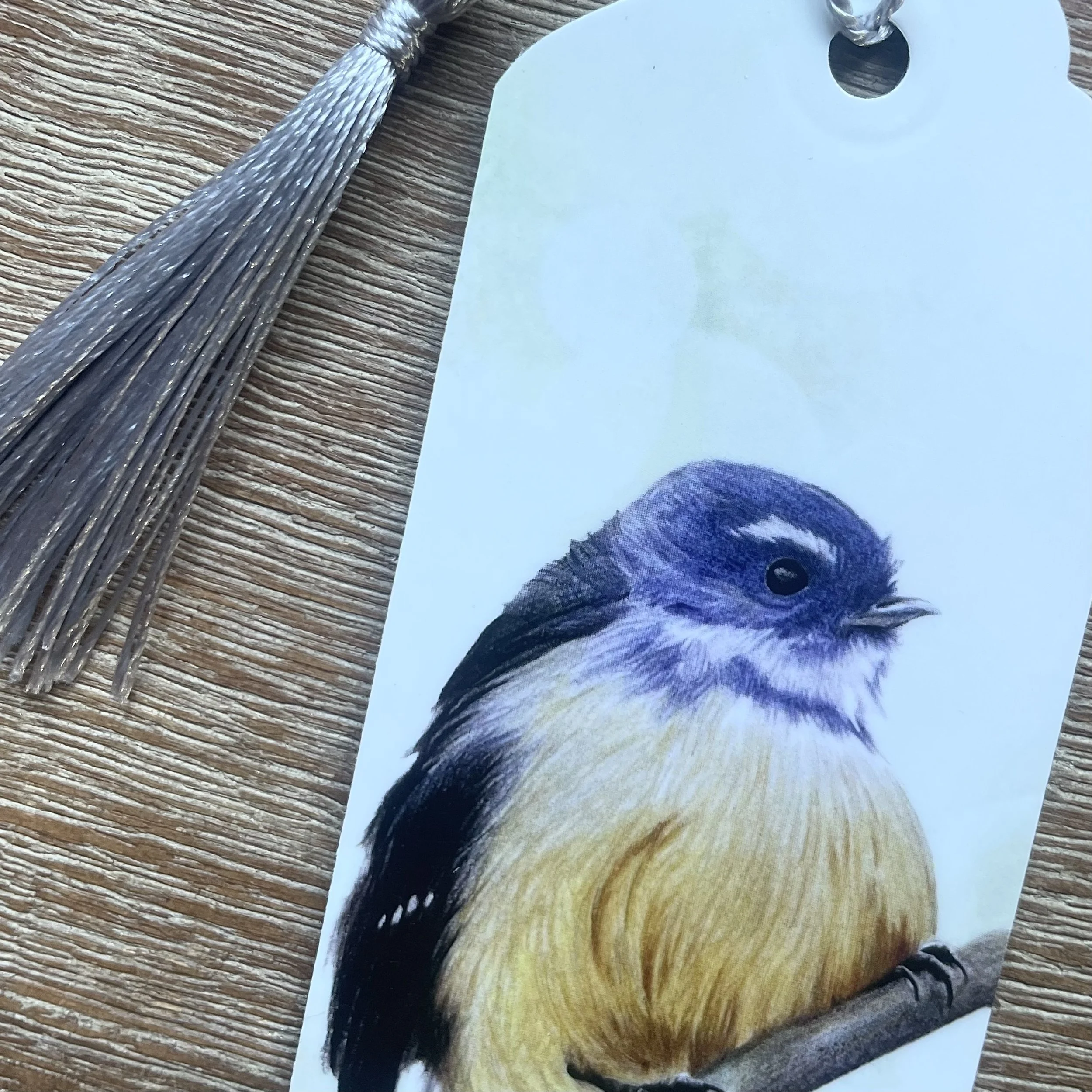 Handmade laminated New Zealand native bird bookmark with tassel designed in Picton Marlborough Sounds