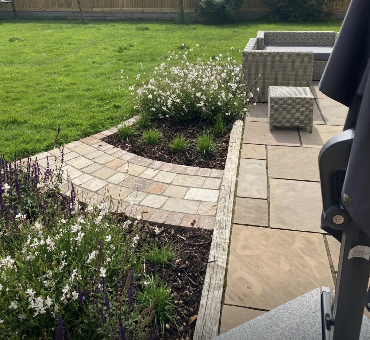 Where old patio meets new pathway and planting is in full swing using our planting plans