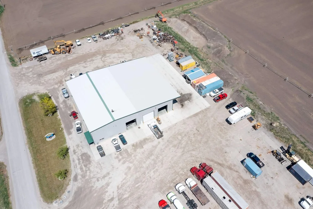 Aerial view of the south end of Itty Bitty Equipment Co. in Richmond, Utah, with Cache Valley farmland behind it