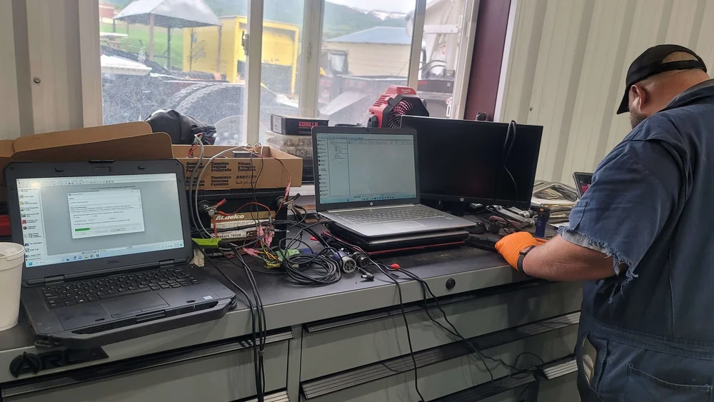 Technician running diagnostic and alignment software at Itty Bitty Equipment Co., Richmond UT