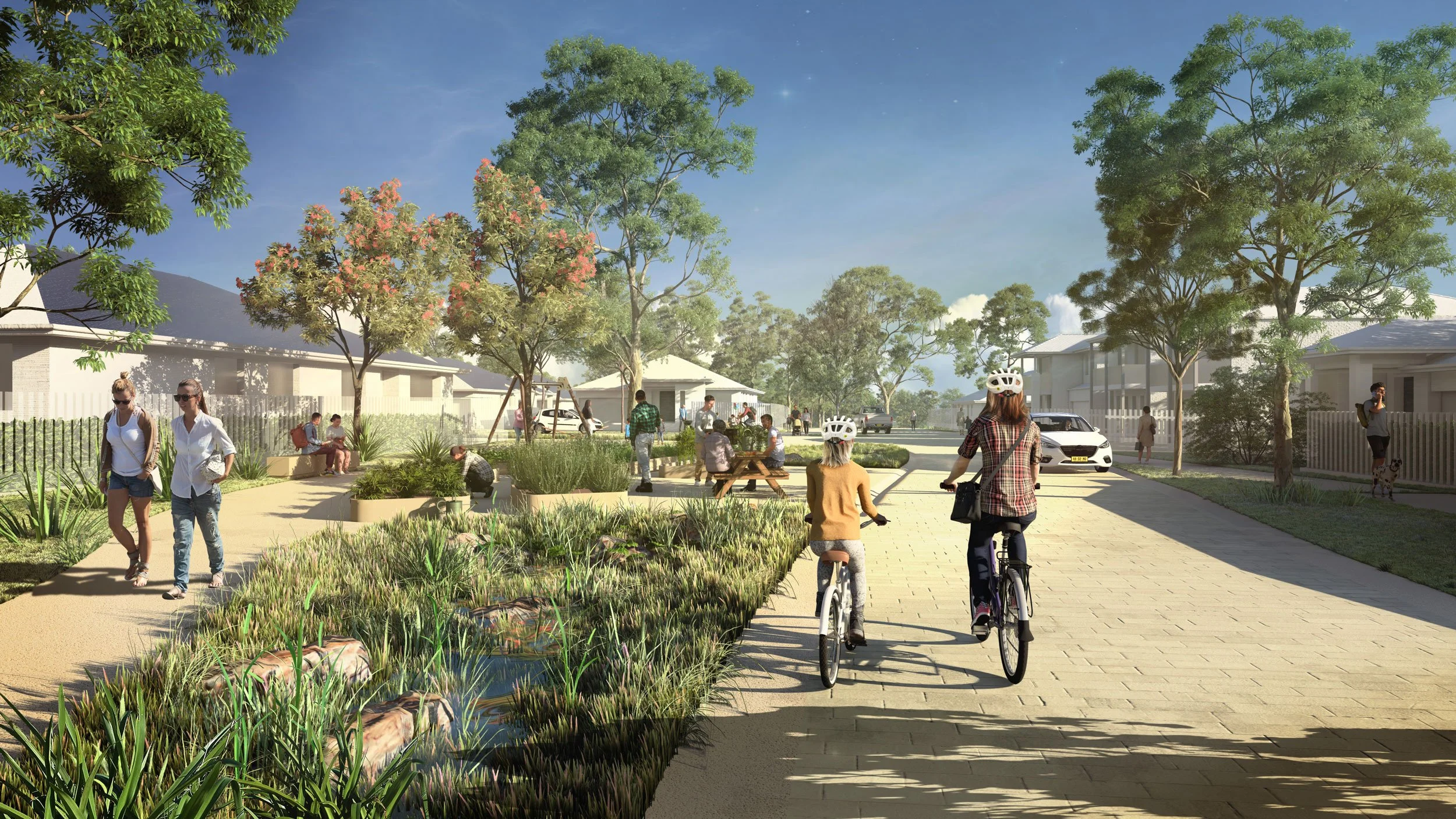 A vibrant neighborhood park scene with people walking, biking, playing, and sitting on benches, surrounded by trees, plants, and modern houses under a clear blue sky.