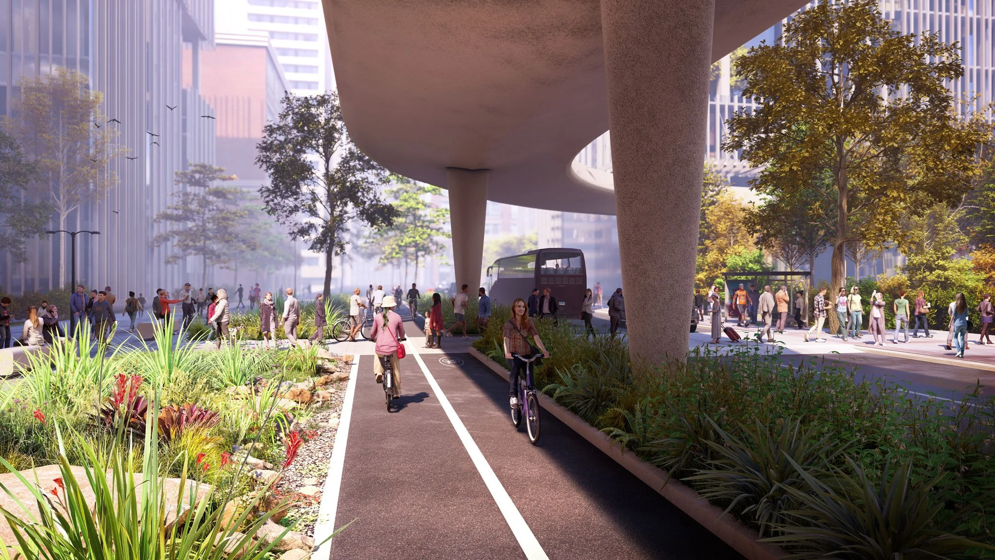 A city park with a dedicated bike lane, walking path, and green space surrounded by tall buildings, trees, and people walking, biking, and relaxing under a large elevated structure.