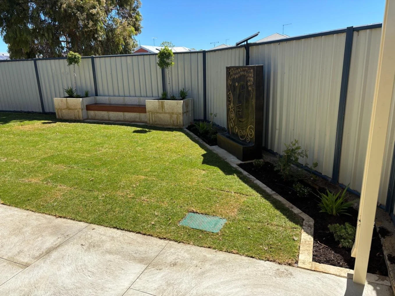 back yard renovation, raised garden bed, bench seat, water feature, natural lawn, reticulation