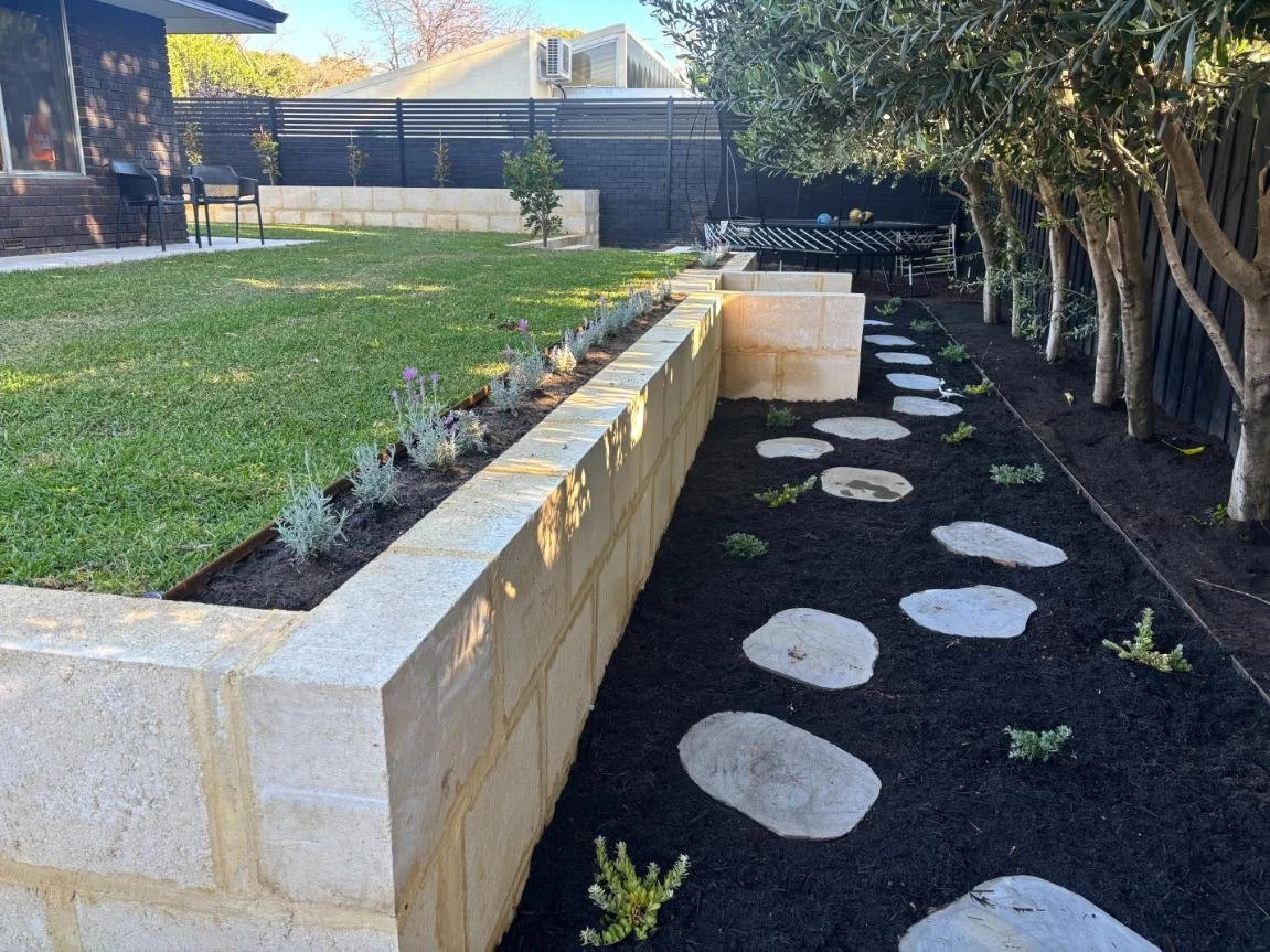 retaining wall, outdoor transformation, natural lawn, limestone blocks, steppers, garden