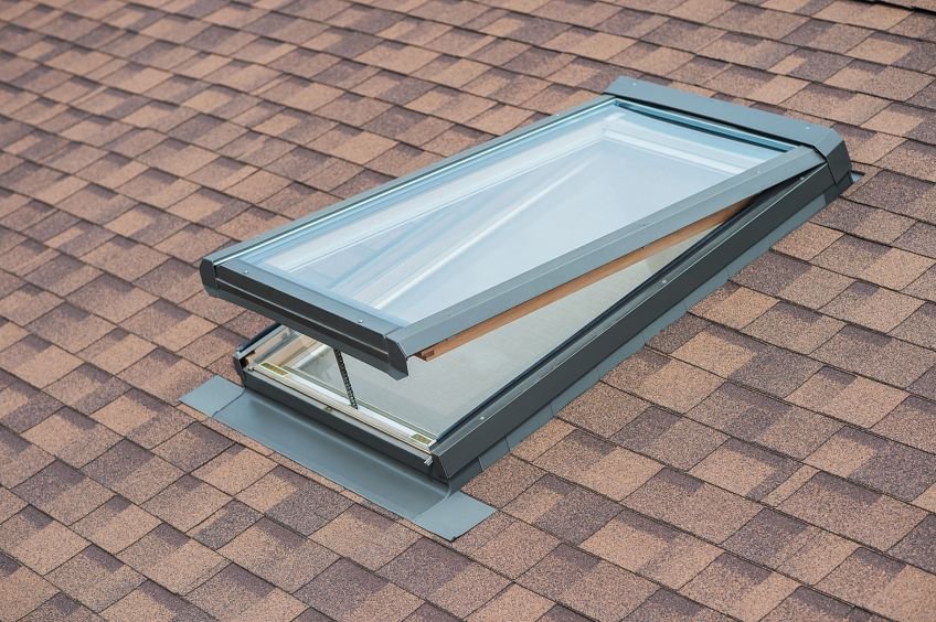 Open skylight on a shingled roof